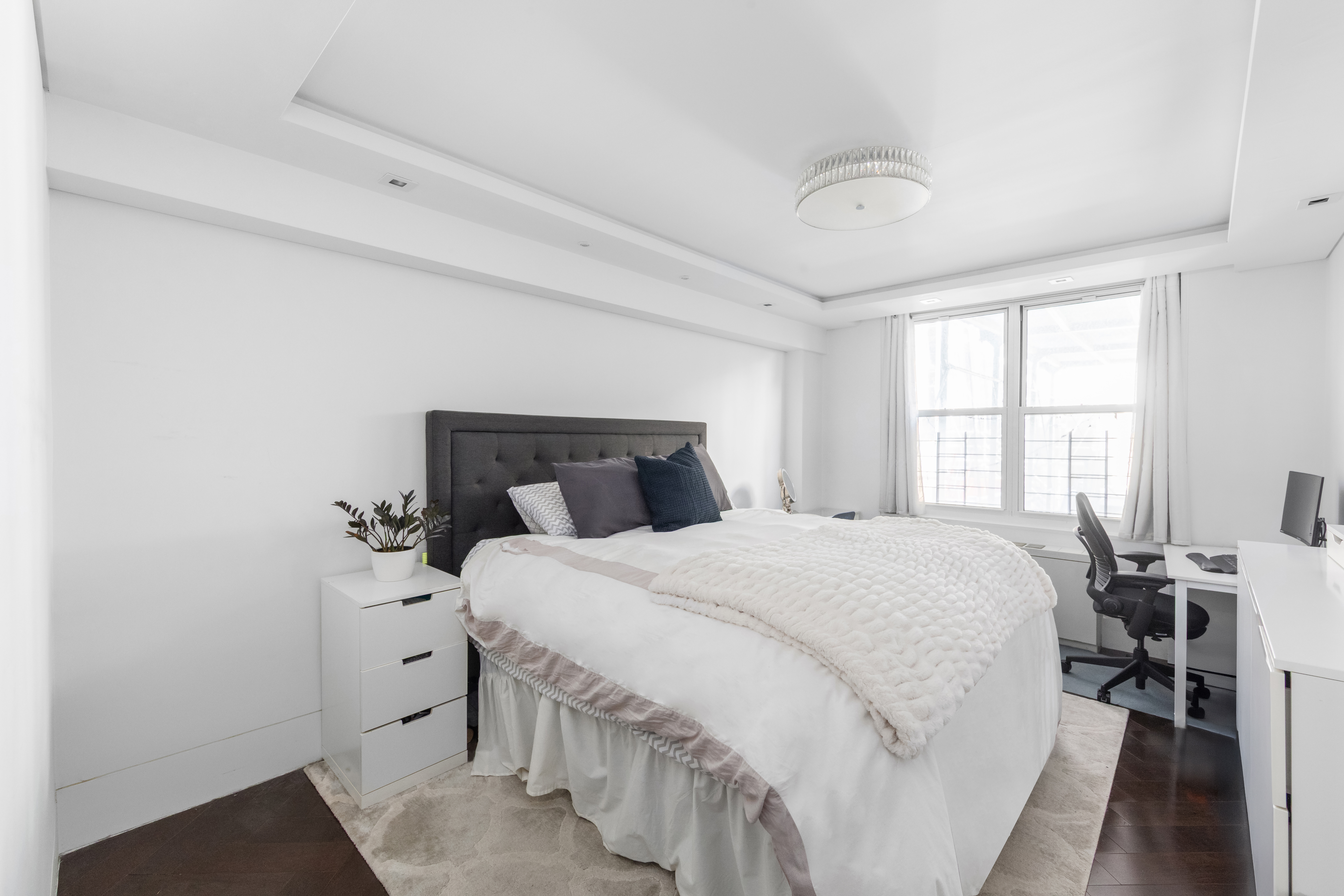 207 East 74th Street, Unit 1J Manhattan, NY 10021 - Photo 5 of 9 a bedroom with a bed and a window