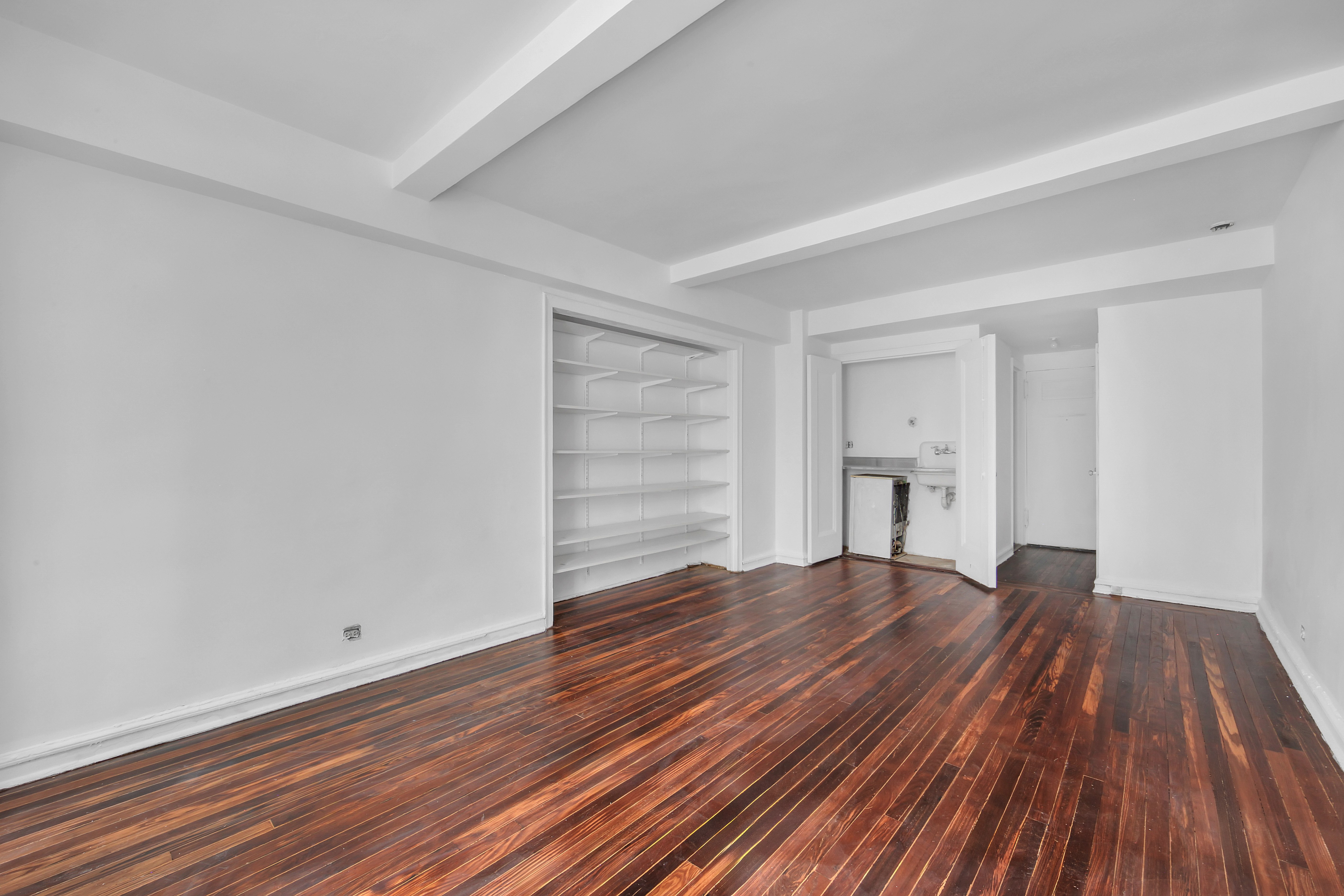 320 East 42nd Street, Unit 516 Manhattan, NY 10017 - Photo 6 of 11 a view of empty room with wooden floor and window
