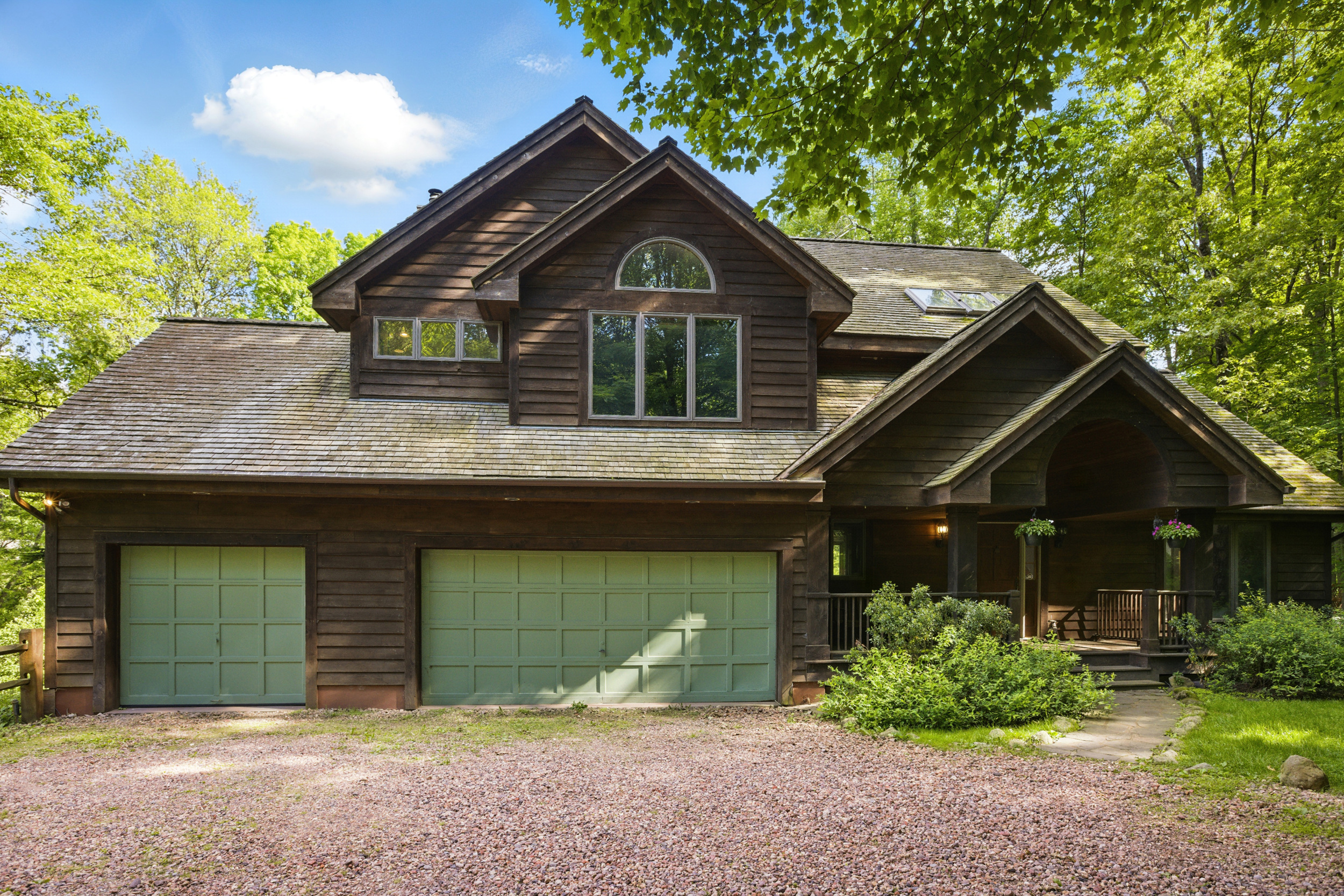 a front view of a house with a yard and garage