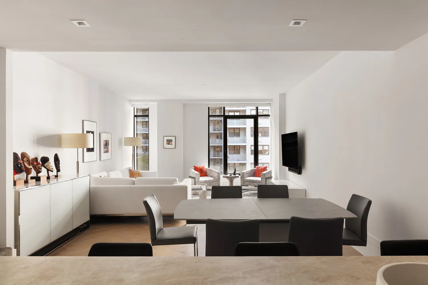 a living room with furniture a flat screen tv and a window