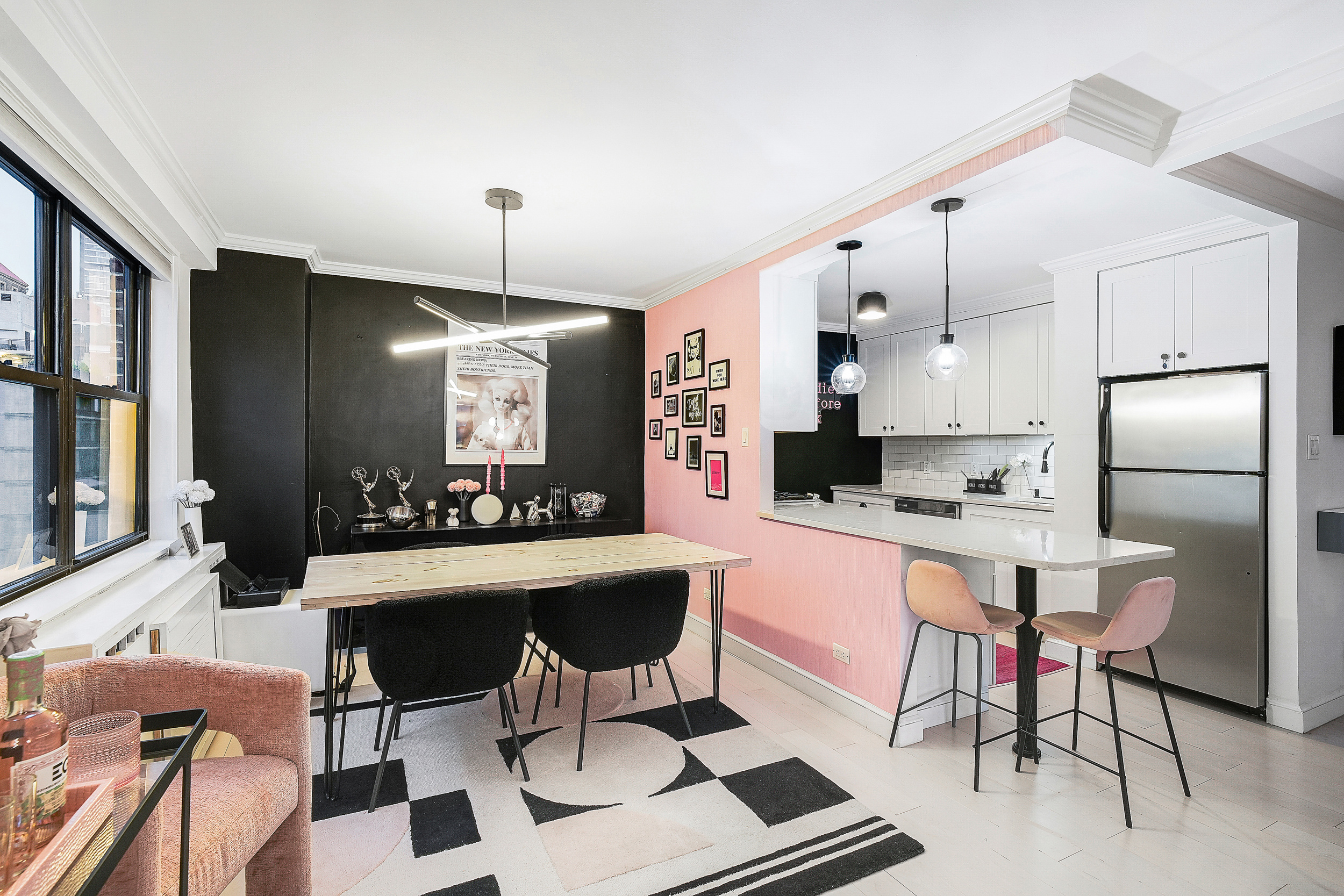 330 3rd Avenue, Unit 15G Manhattan, NY 10010 - Photo 5 of 14 a kitchen with stainless steel appliances kitchen island granite countertop a dining table chairs and a refrigerator