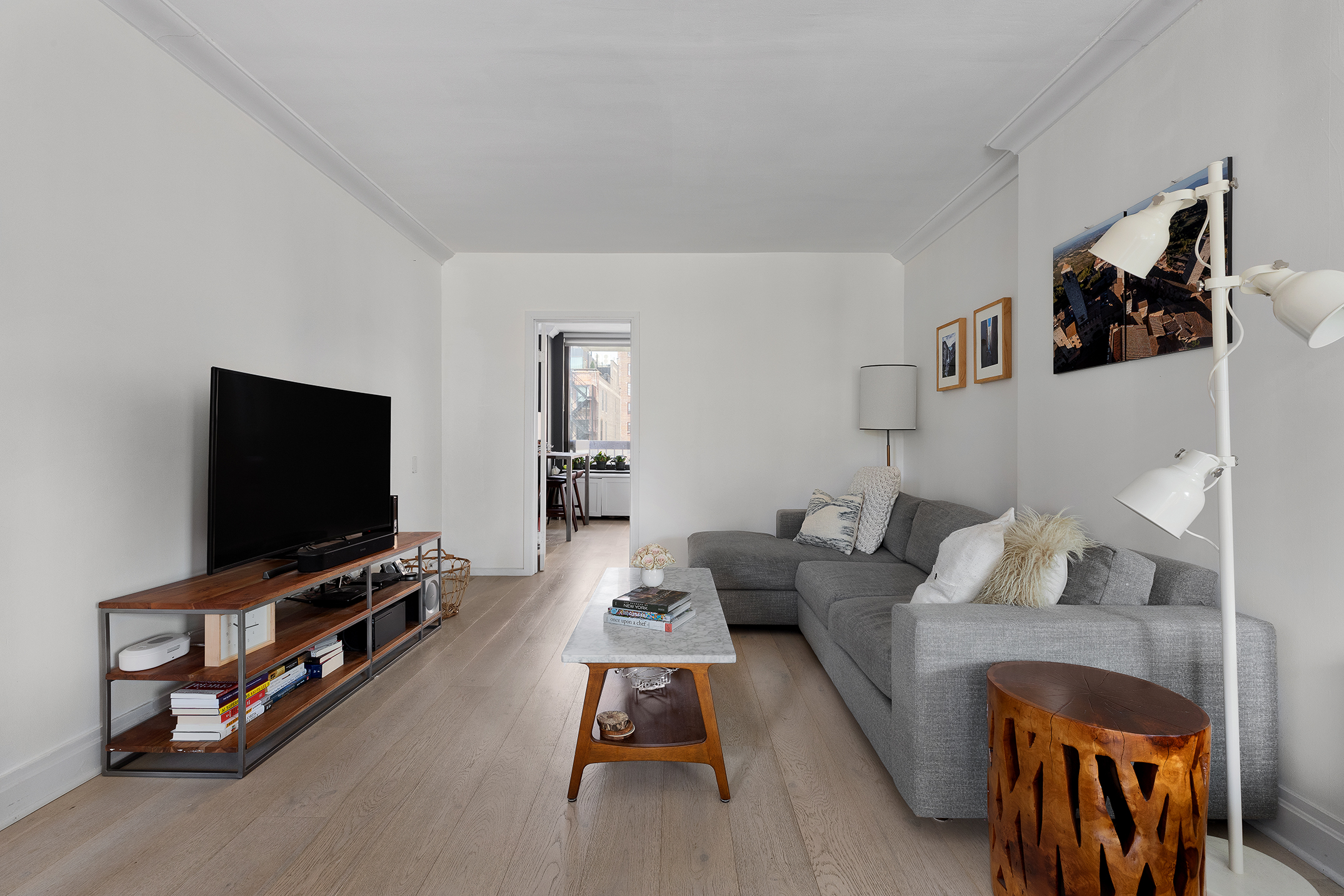 111 East 30th Street, Unit 16C Manhattan, NY 10016 - Photo 4 of 13 a living room with furniture and a flat screen tv