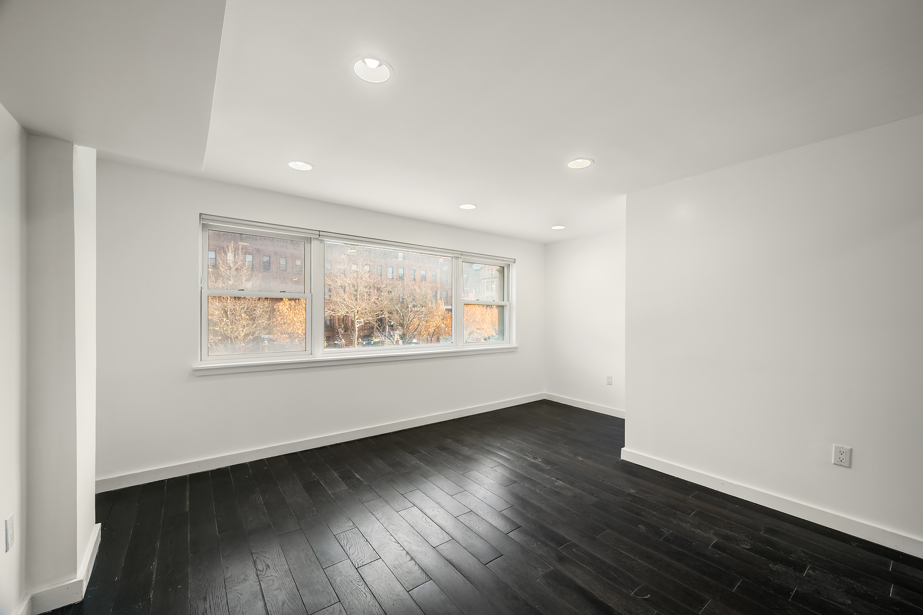 273 Lenox Avenue Manhattan, NY 10027 - Photo 12 of 15 an empty room with wooden floor and window