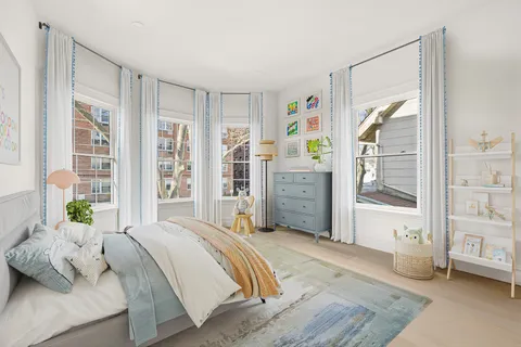 a view of kitchen with cabinets and window