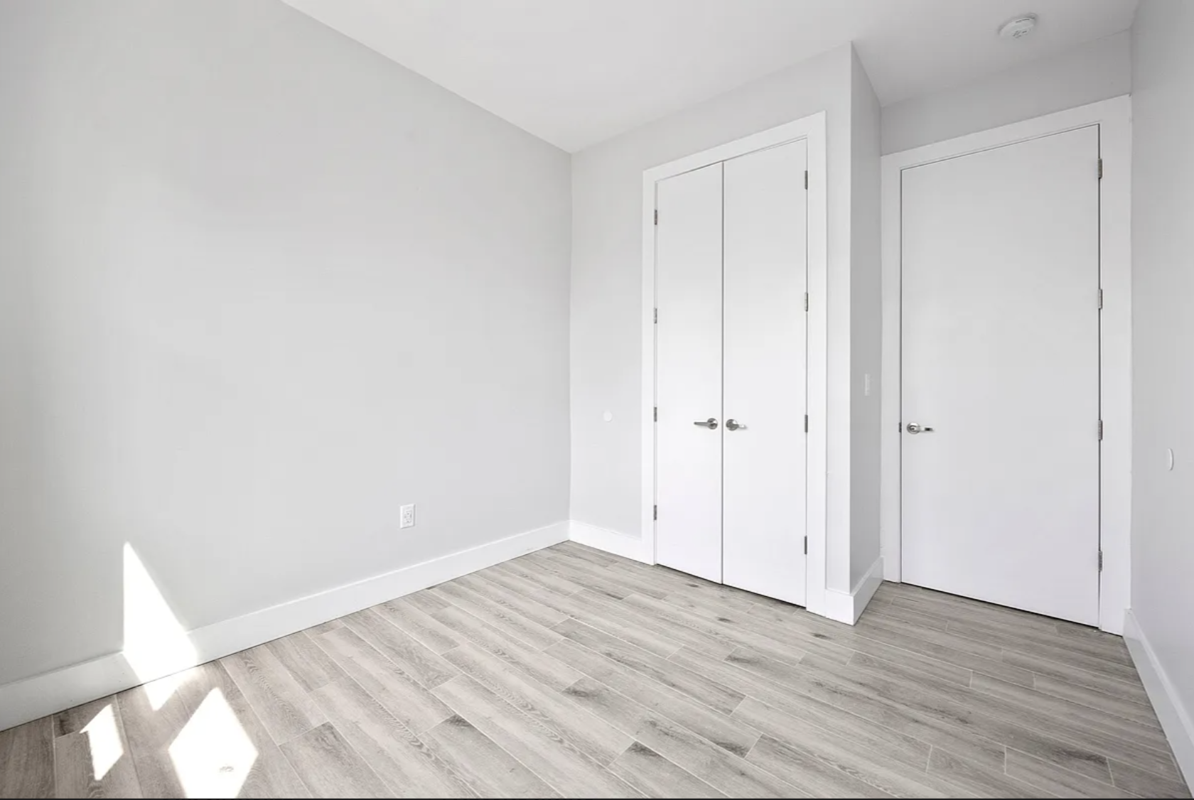 586 Marcy Avenue, Unit 3A Brooklyn, NY 11206 - Photo 5 of 7 a view of an empty room with wooden floor