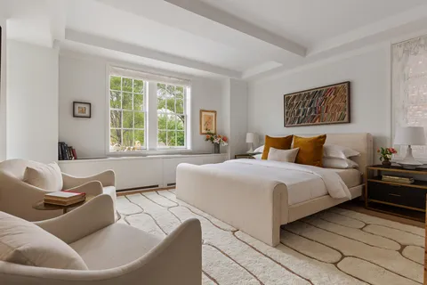 a bedroom with a large bed and a couch