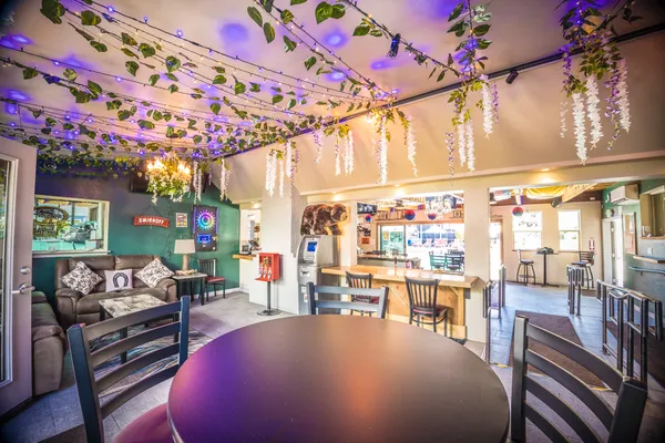 a view of a chairs and tables in patio with a barbeque
