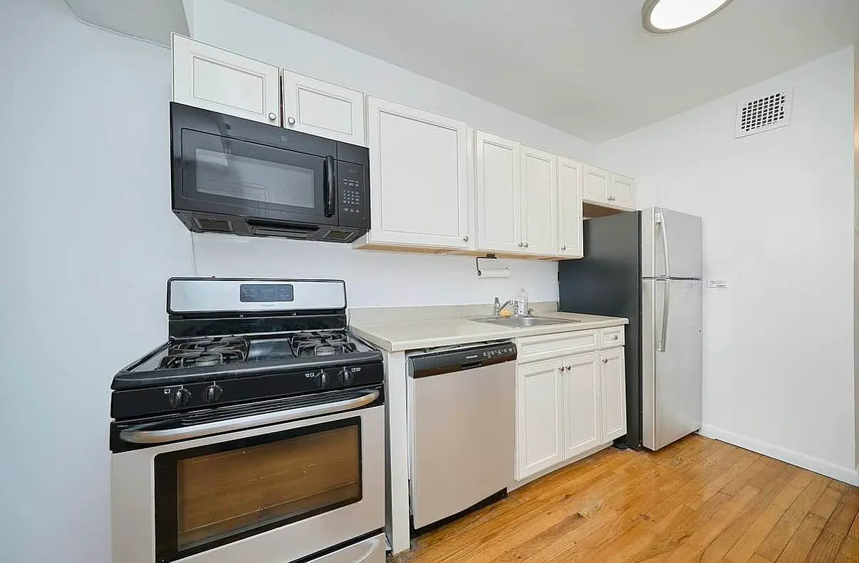 103 West 105th Street, Unit 2A Manhattan, NY 10025 - Photo 5 of 10 a kitchen with a stove and a microwave