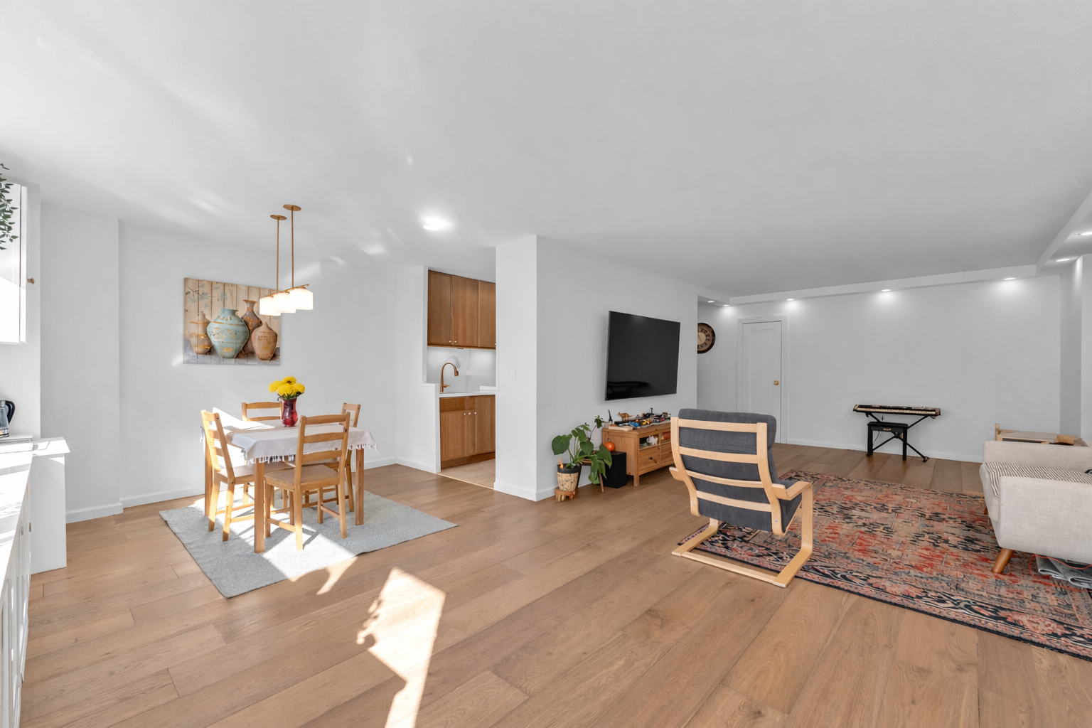 150 West End Avenue, Unit 21M Manhattan, NY 10023 - Photo 2 of 13 a living room with furniture a flat screen tv and kitchen view