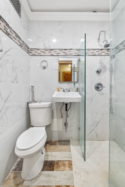 419 Clermont Avenue Brooklyn, NY 11238 - Photo 7 of 14 a bathroom with a toilet sink and shower