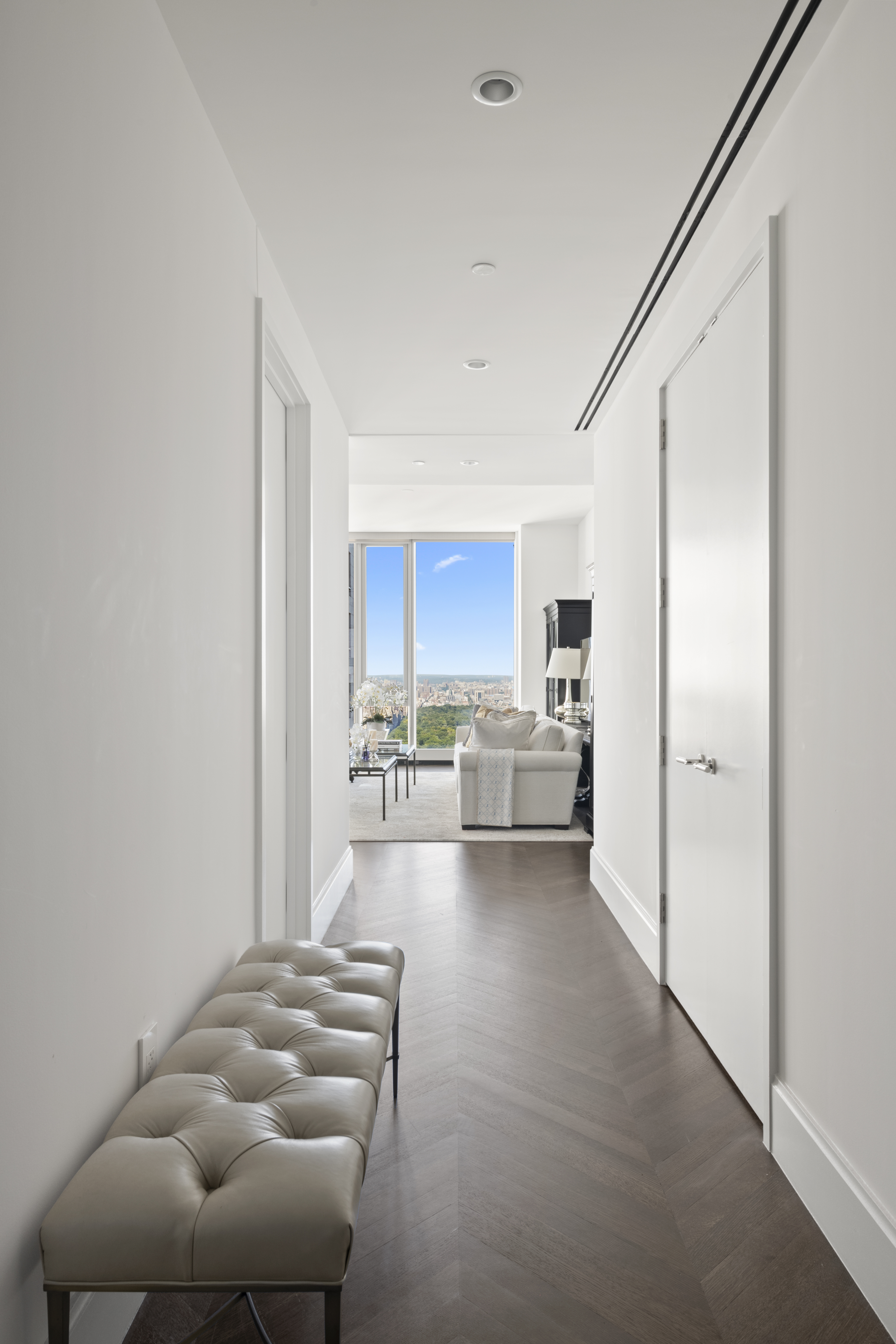 217 West 57th Street, Unit 58W Manhattan, NY 10019 - Photo 7 of 30 a living room with furniture and a kitchen