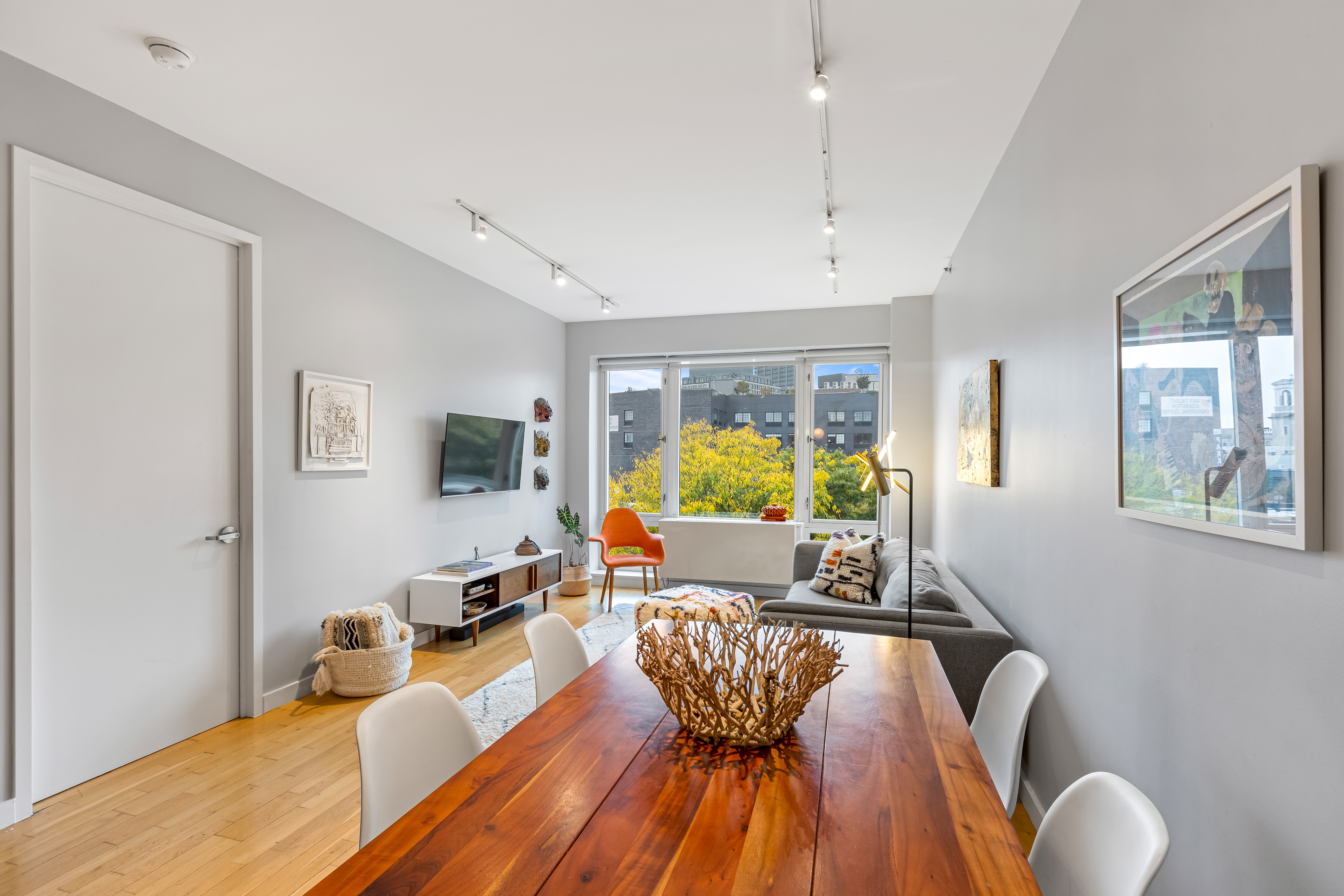 545 Washington Avenue, Unit 604 Brooklyn, NY 11238 - Photo 4 of 16 a living room with furniture and a wooden floor