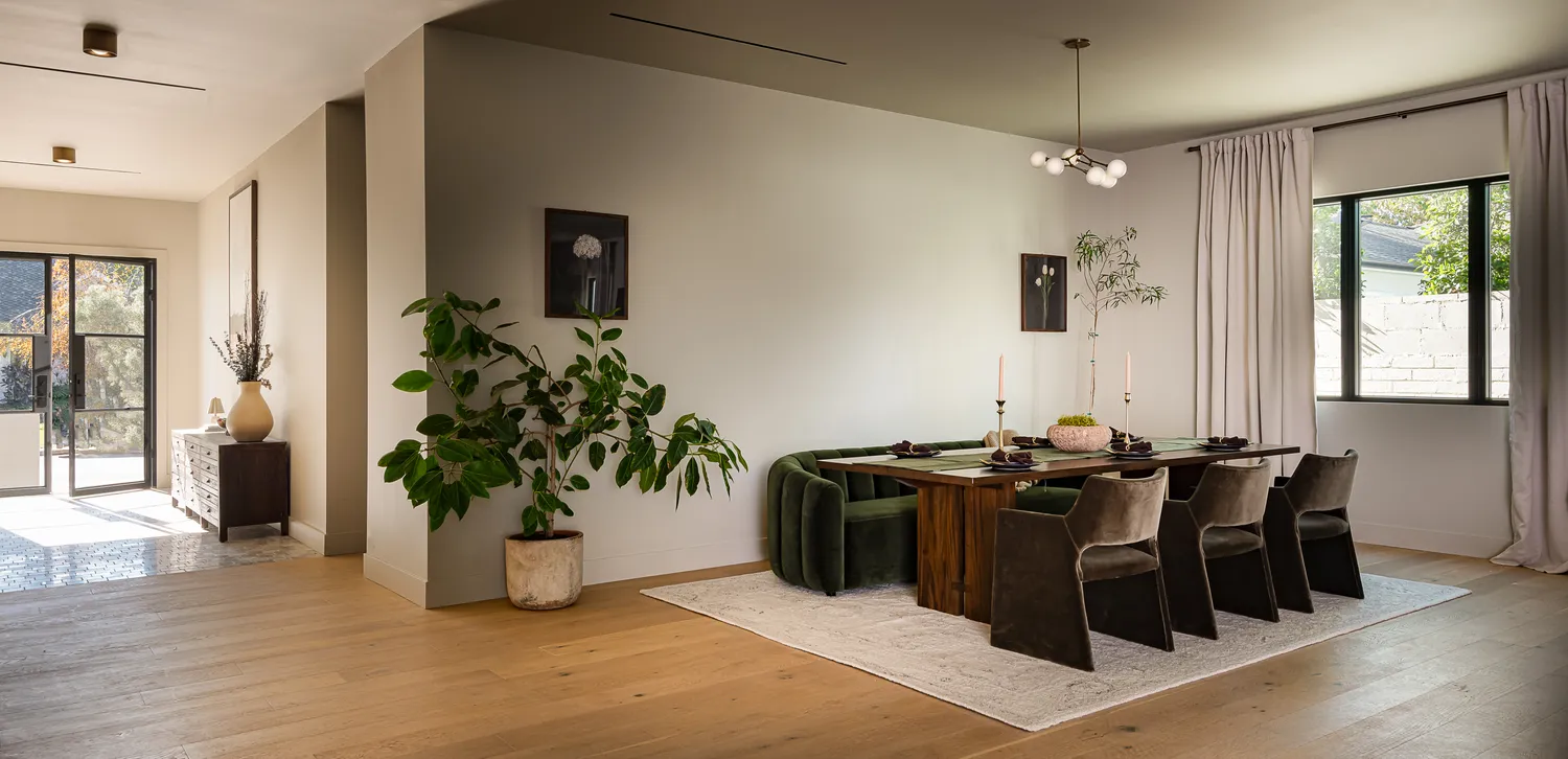 a kitchen with a stove a sink and white cabinets