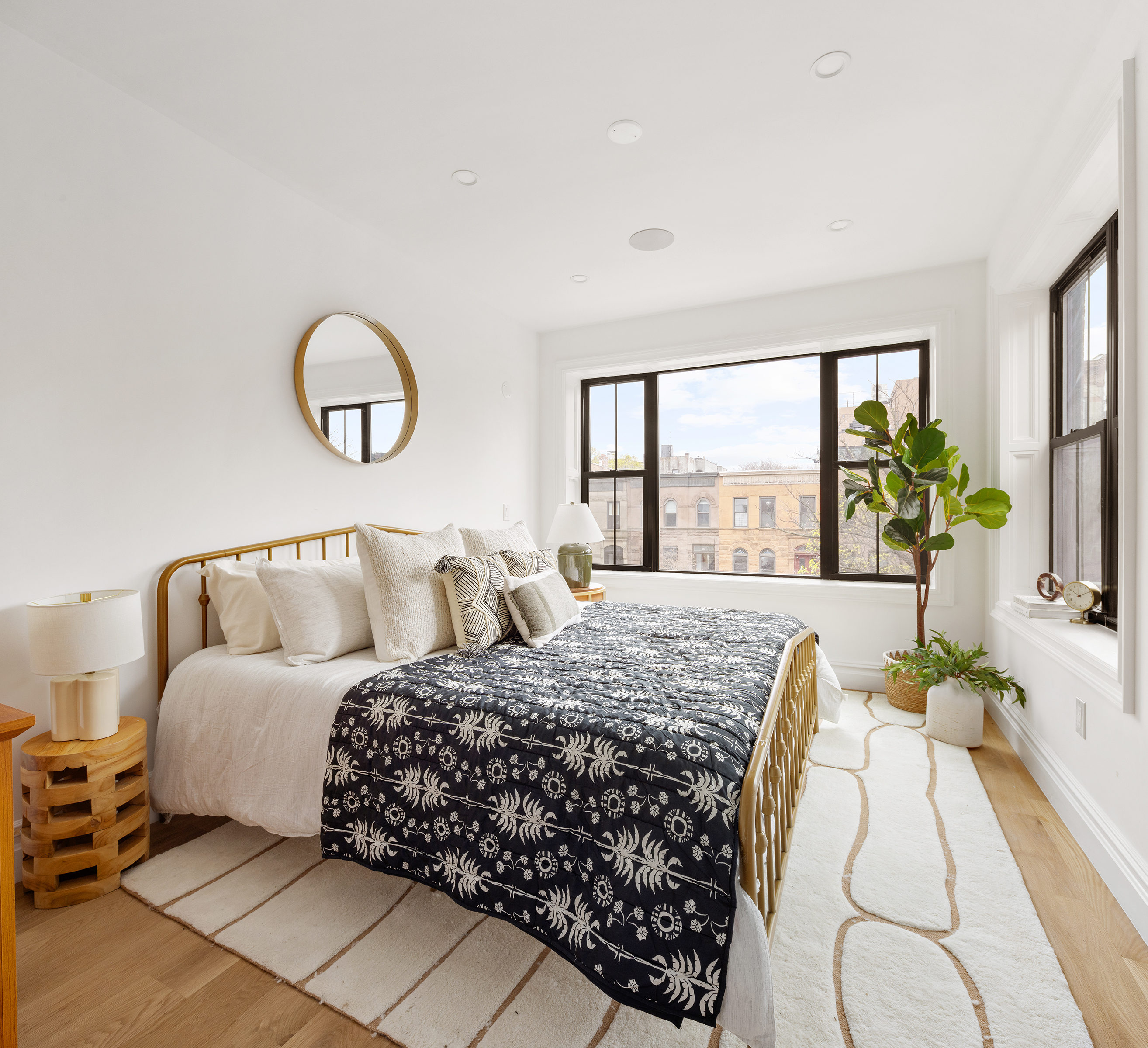 557 Saint Marks Avenue Brooklyn, NY 11216 - Photo 8 of 13 a bedroom with a large bed and a large window