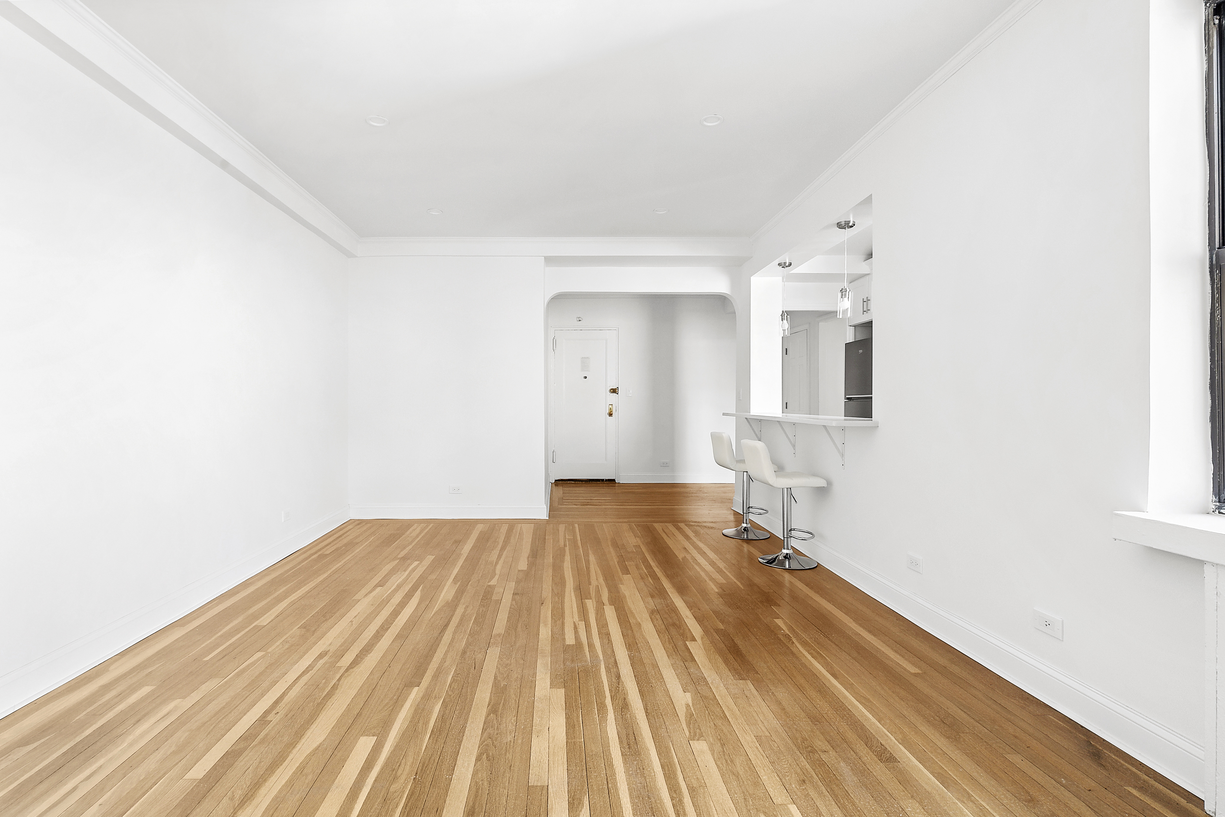 159-34 Riverside Drive West, Unit 7L90 Manhattan, NY 10032 - Photo 6 of 22 a view of a bedroom with wooden floor and bathroom