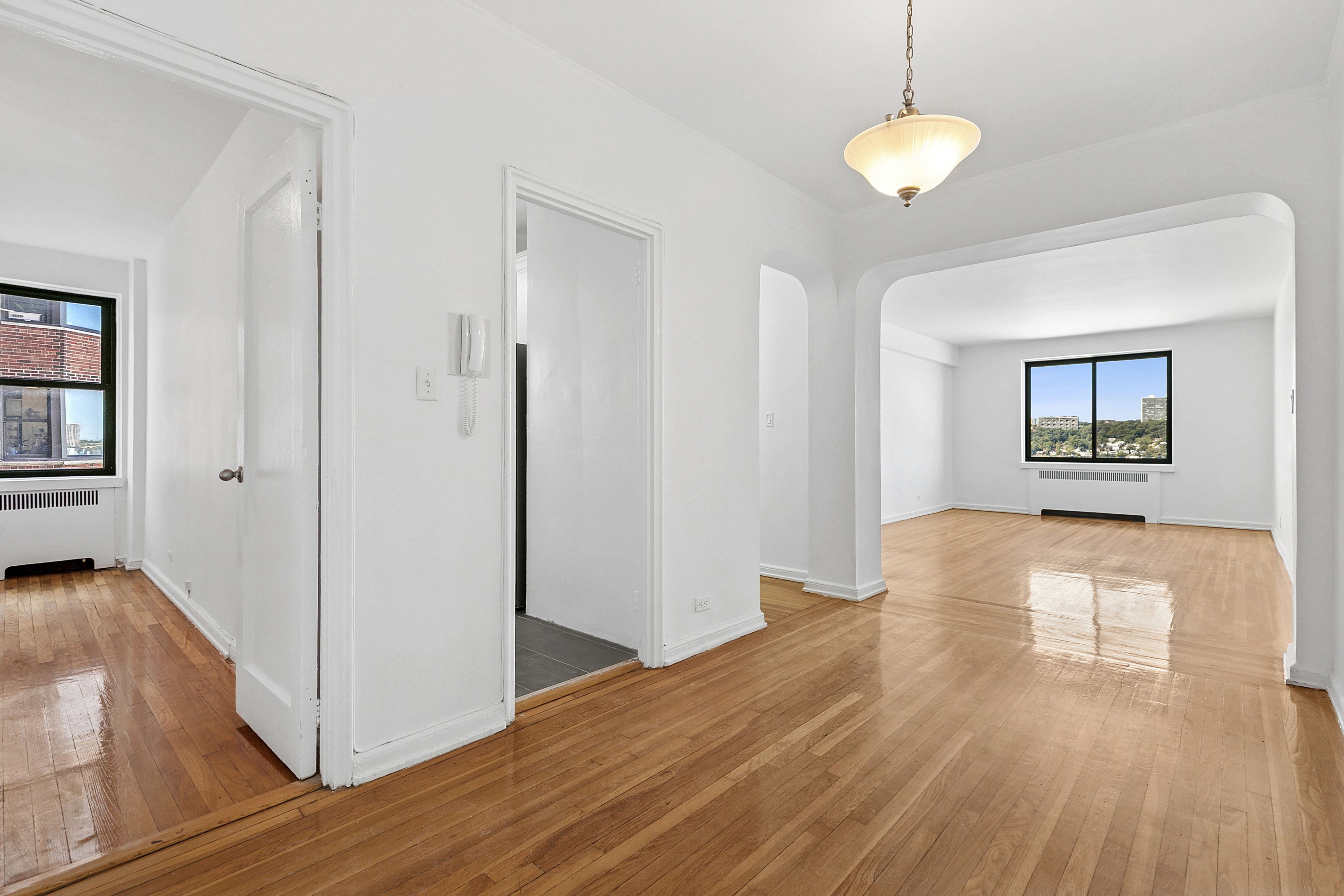a view of a room with wooden floor and window