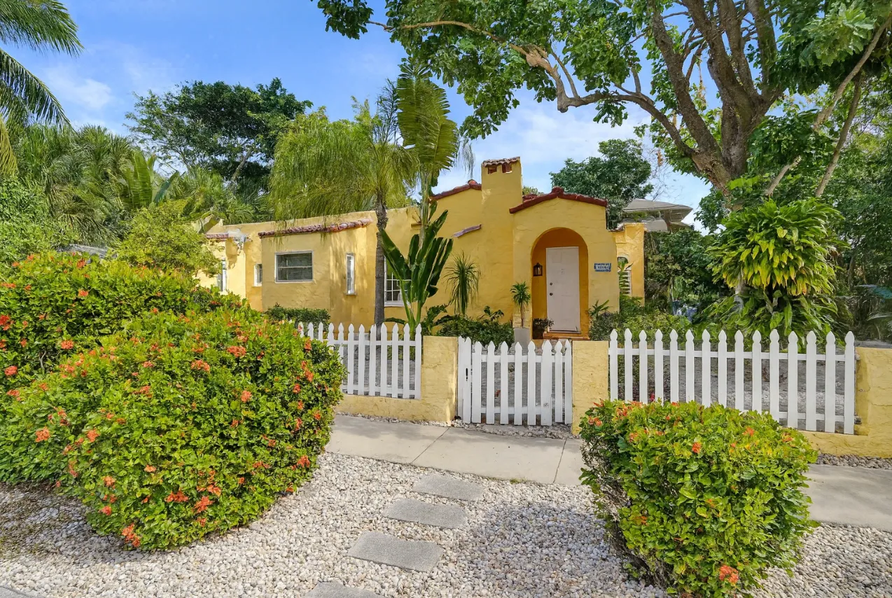 a view of a house with wooden fence