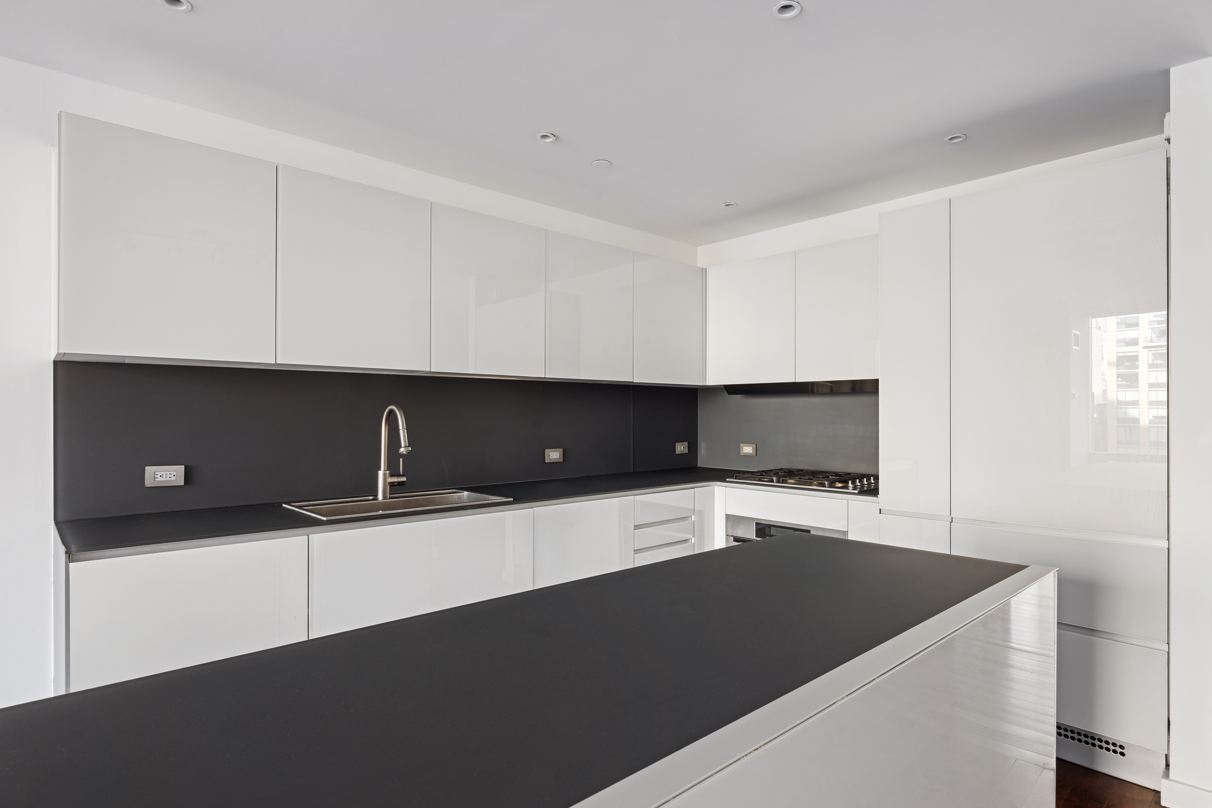 166 West 18th Street, Unit 7D Manhattan, NY 10011 - Photo 3 of 10 a kitchen with granite countertop a sink and a stove