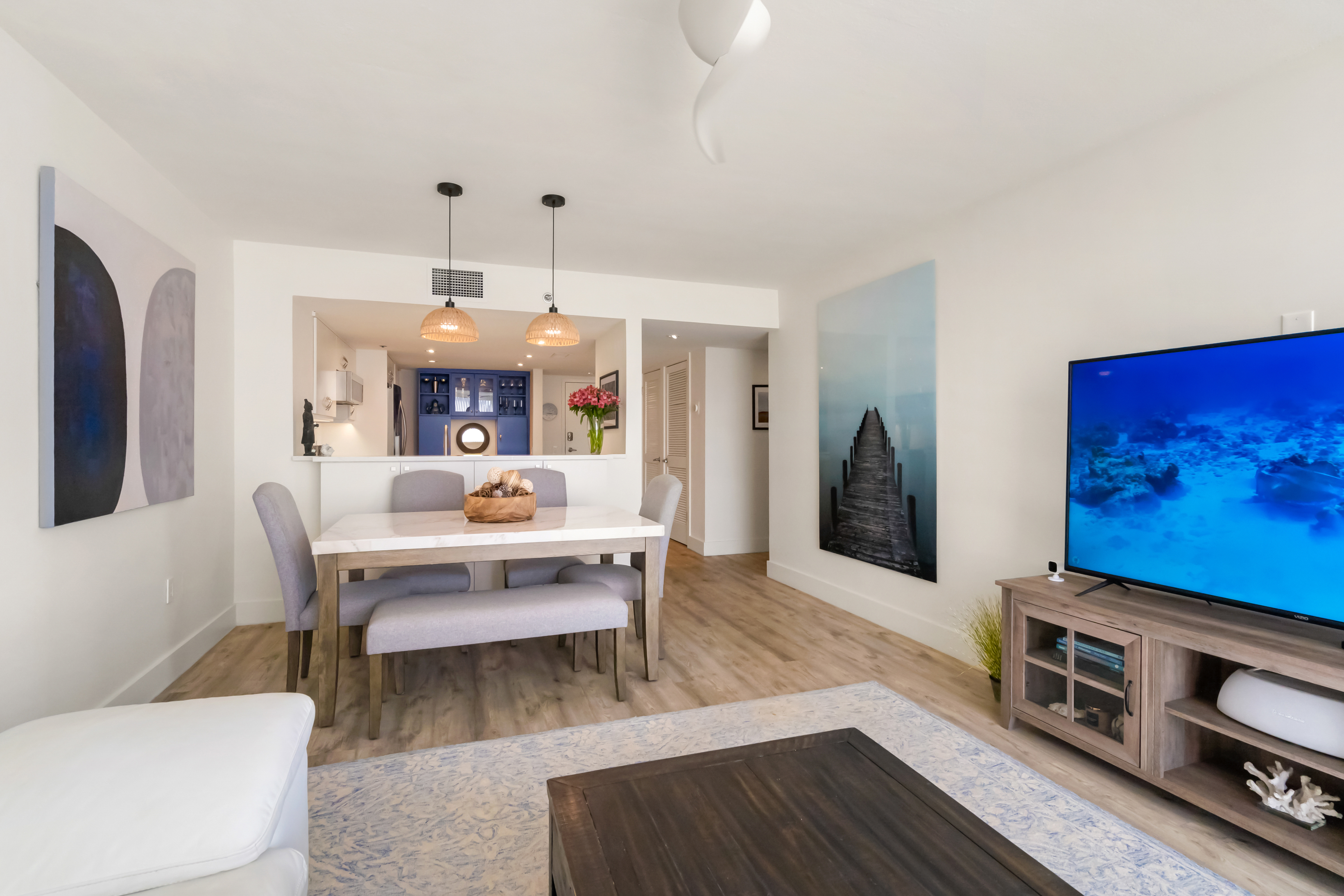 2700 North Highway A1a, Unit 207 Fort Pierce, FL 34949 - Photo 17 of 36 a living room with furniture a flat screen tv and a dining table