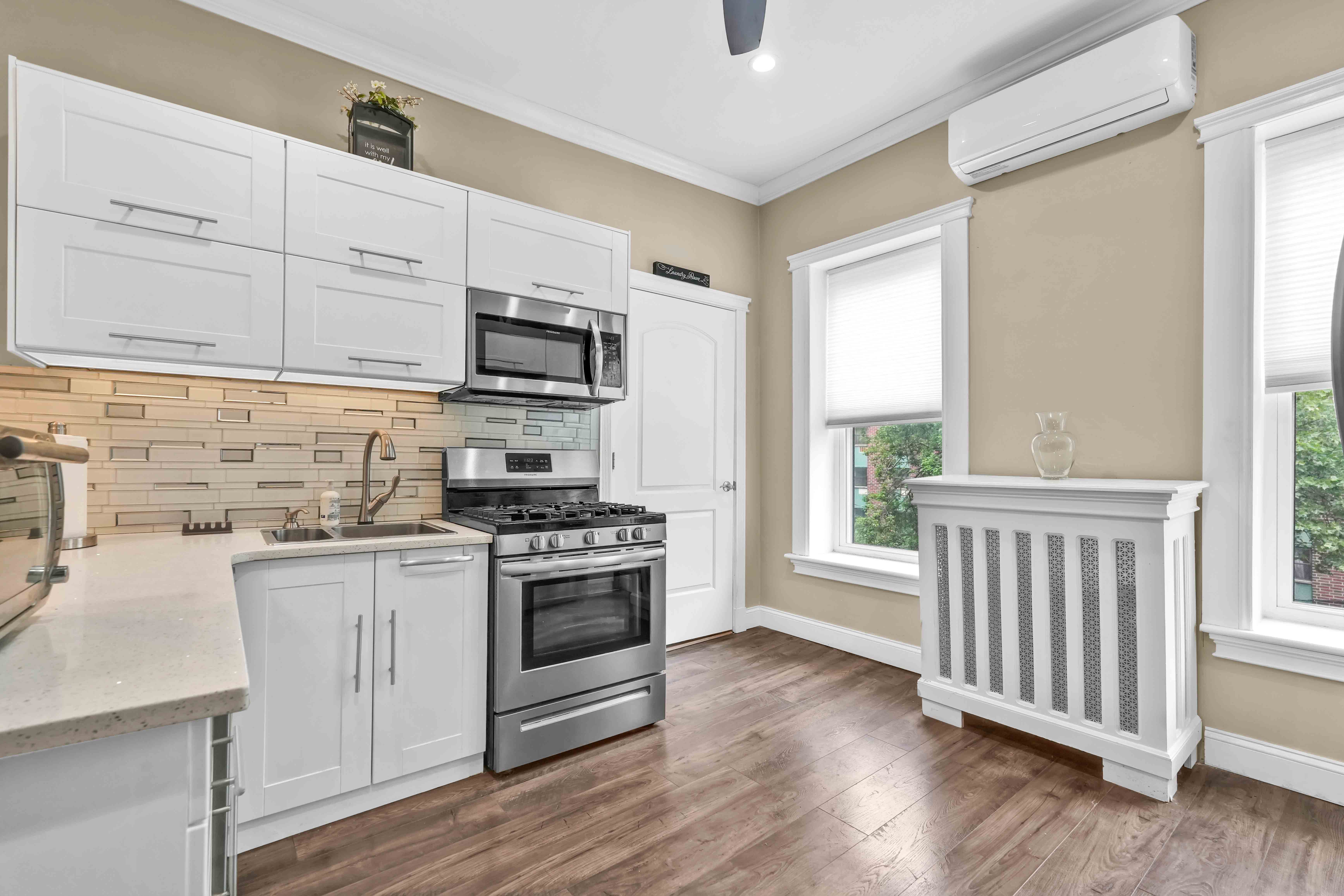 519 Monroe Street Brooklyn, NY 11221 - Photo 12 of 55 a kitchen with stainless steel appliances granite countertop a stove a sink and white cabinets