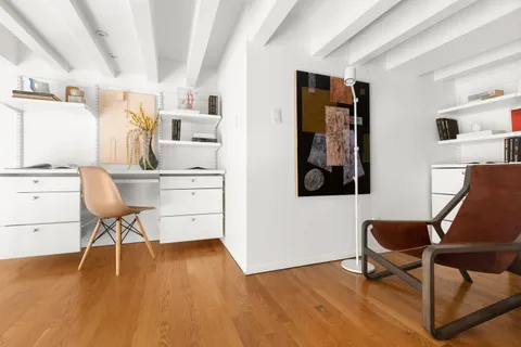 a workspace with furniture and wooden floor