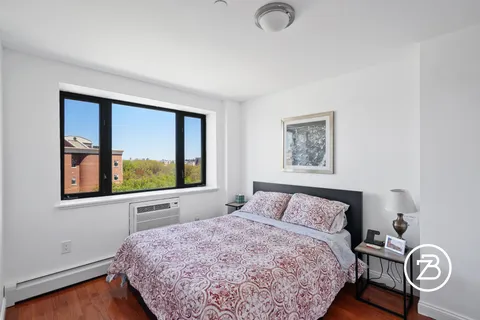 a bedroom with a bed and painting on the wall