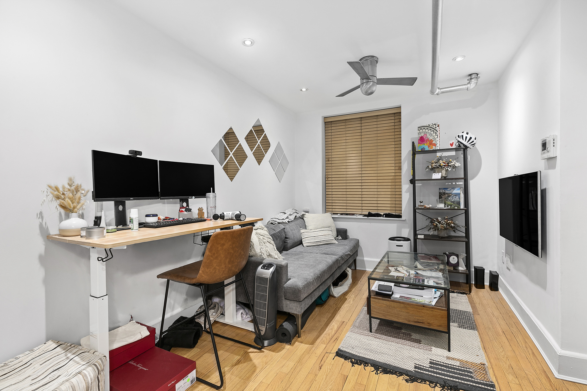 140 West 10th Street, Unit BTW Manhattan, NY 10014 - Photo 2 of 8 a living room with furniture and a flat screen tv