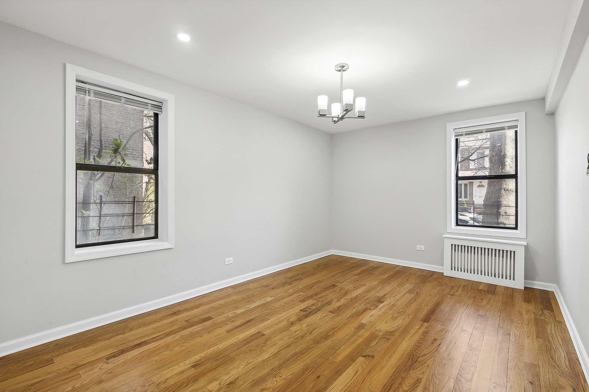 40 89th Street, Unit 1F Brooklyn, NY 11209 - Photo 7 of 13 a view of empty room with wooden floor and fan