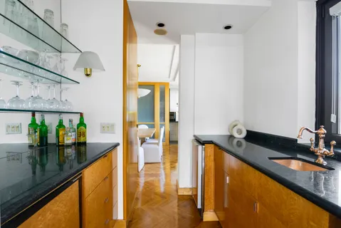 a view of a a dining room with furniture window and wooden floor