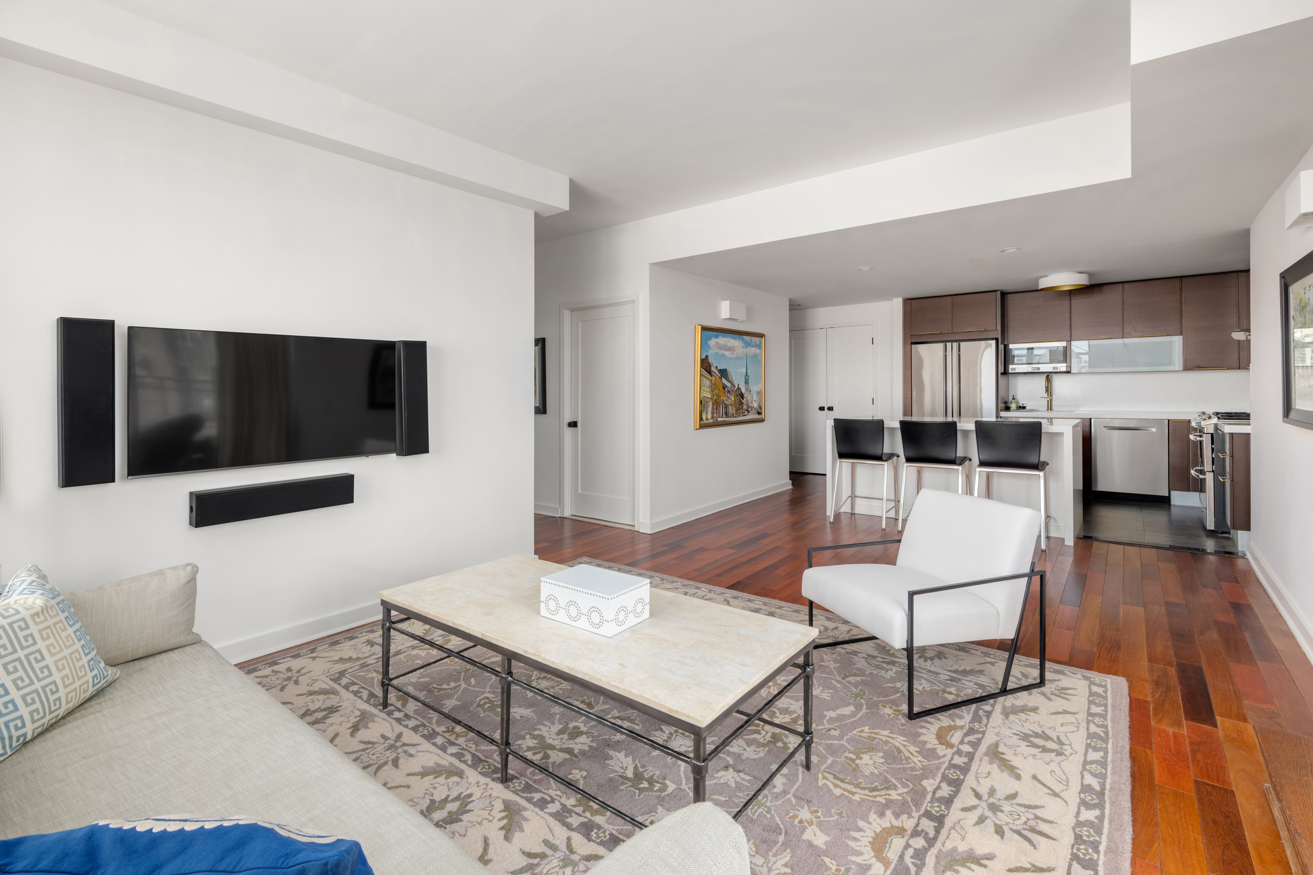 301 West 118th Street, Unit PH1C Manhattan, NY 10026 - Photo 2 of 12 a living room with furniture and a flat screen tv