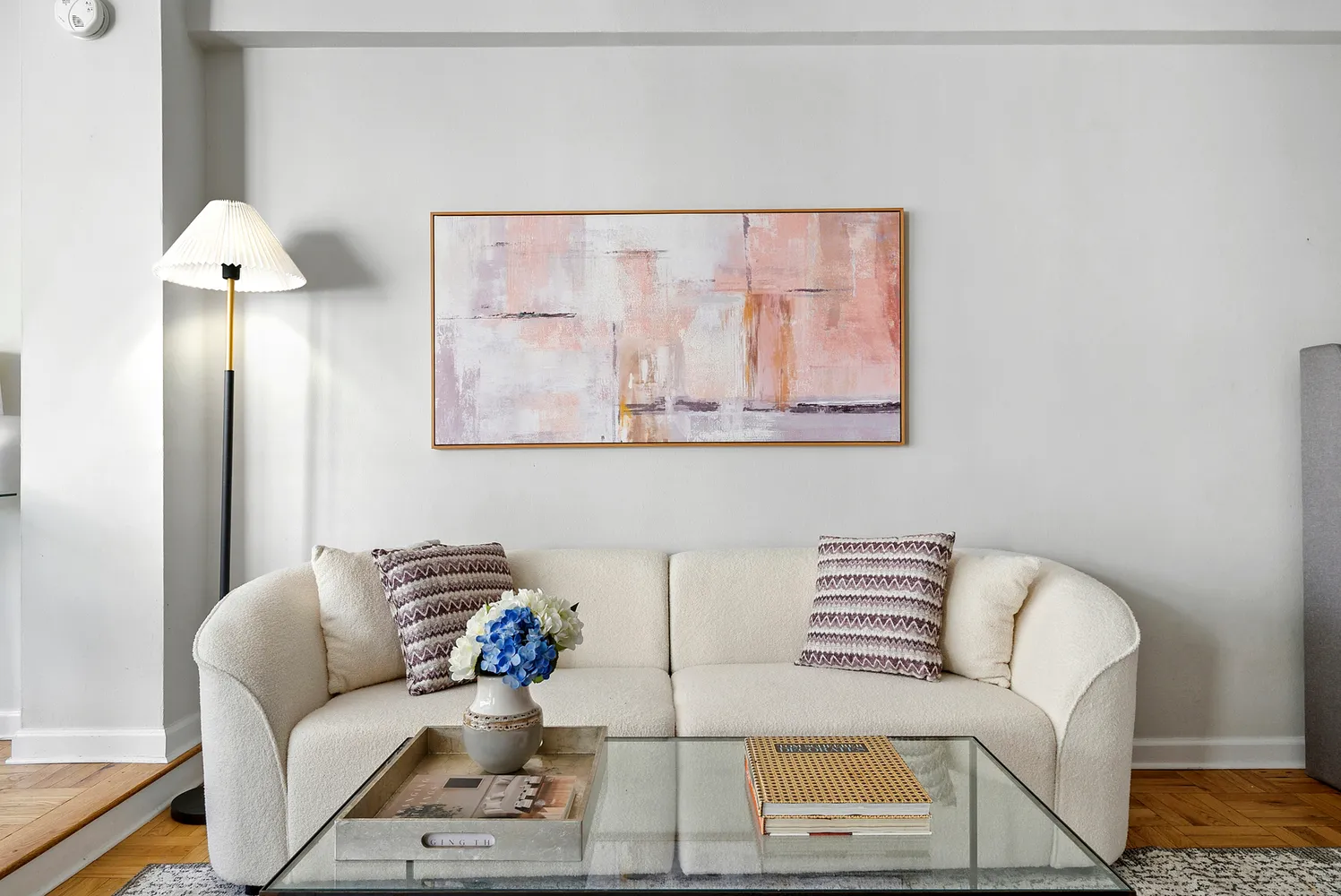 a living room with furniture and a painting