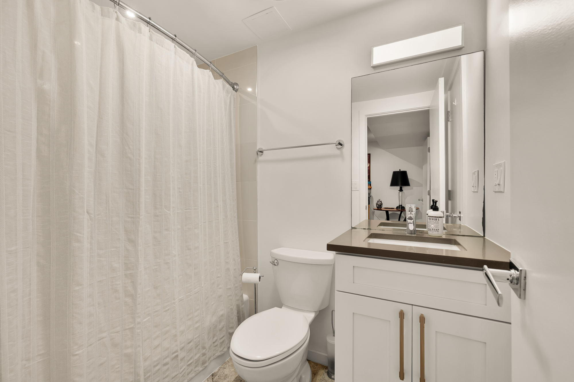 2710 Brandywine Street Northwest Washington, DC 20008 - Photo 57 of 74 a bathroom with a toilet a sink and a mirror