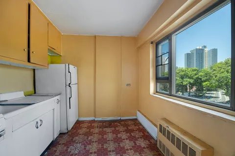 a kitchen with a refrigerator and window