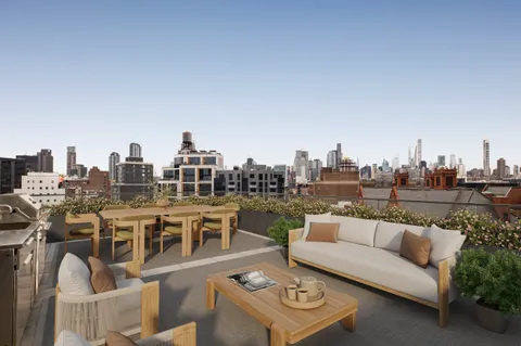 a view of a terrace with furniture and a view of city