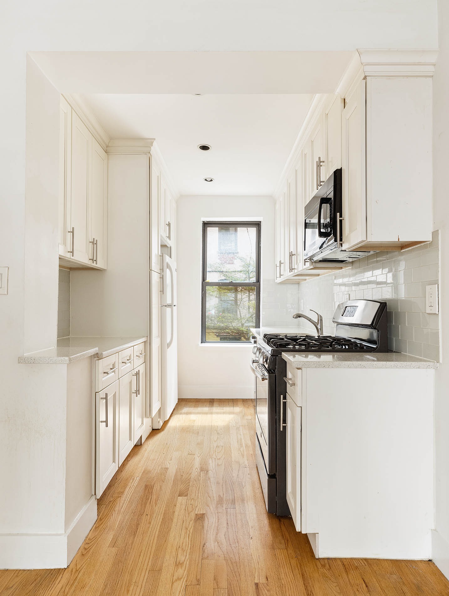2116 Dorchester Road, Unit 1I Brooklyn, NY 11226 - Photo 3 of 15 a kitchen with stainless steel appliances granite countertop a stove a sink and a refrigerator