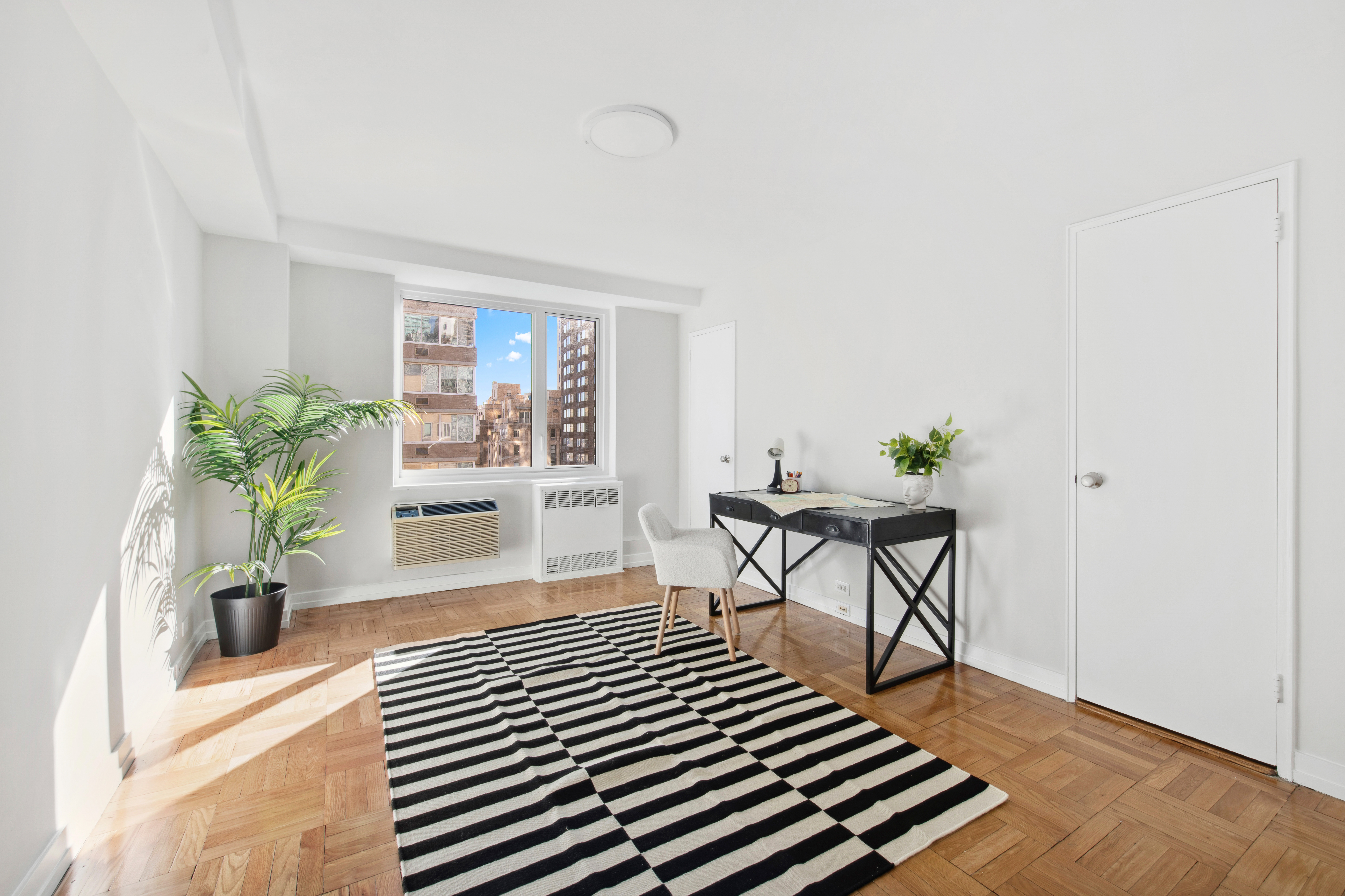 411 East 53rd Street, Unit 20A Manhattan, NY 10022 - Photo 8 of 12 a living room with furniture and a potted plant