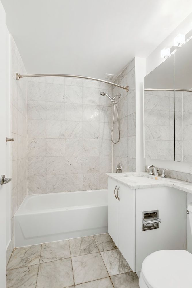 199 Bowery, Unit 5A Manhattan, NY 10002 - Photo 5 of 6 a bathroom with a sink a toilet and bathtub