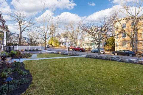 a view of yard with swimming pool and green space