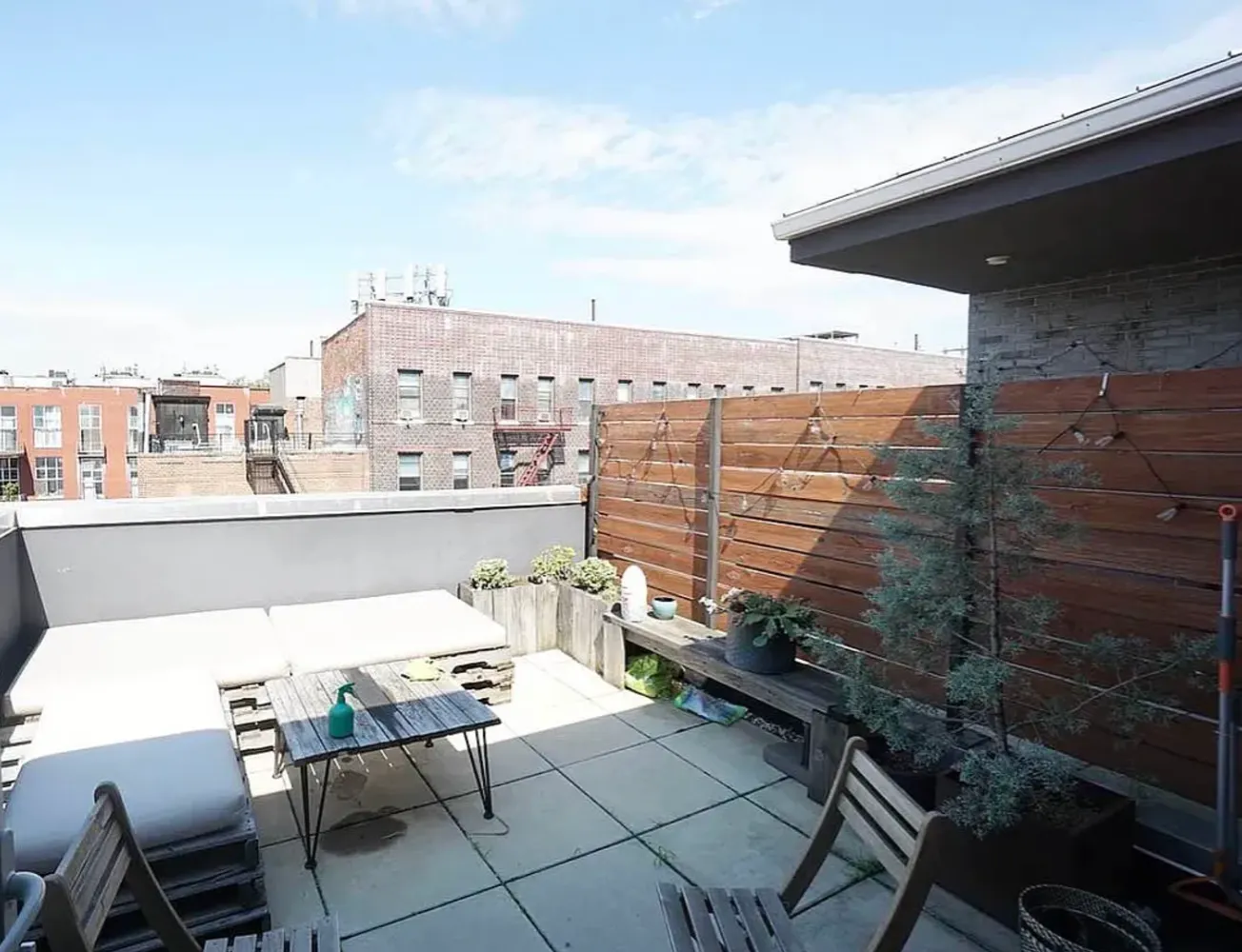 a terrace with outdoor seating city view and barbeque oven