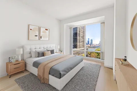 a bedroom with a bed and a large window