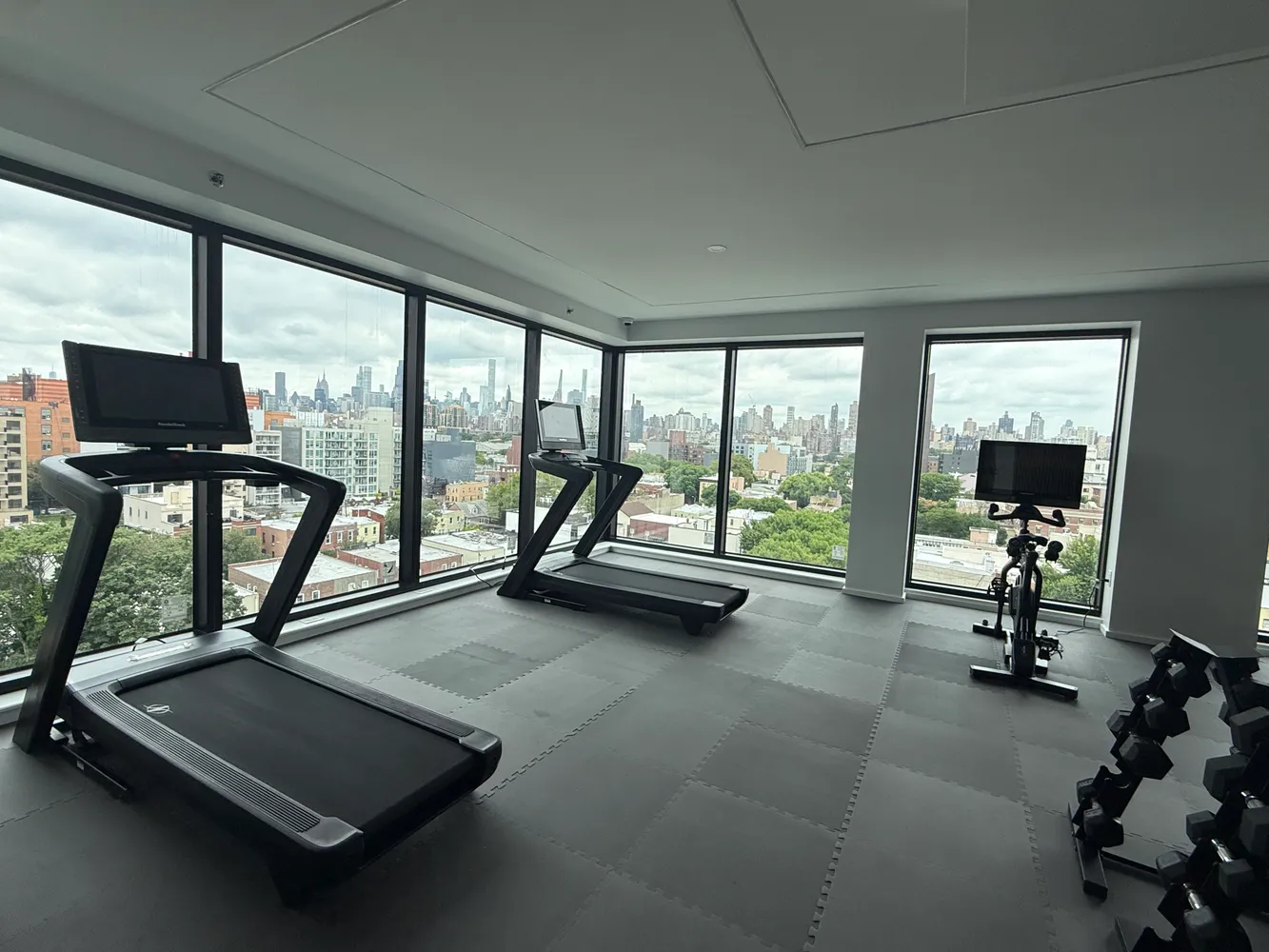 a view of a room with gym equipment and a large window