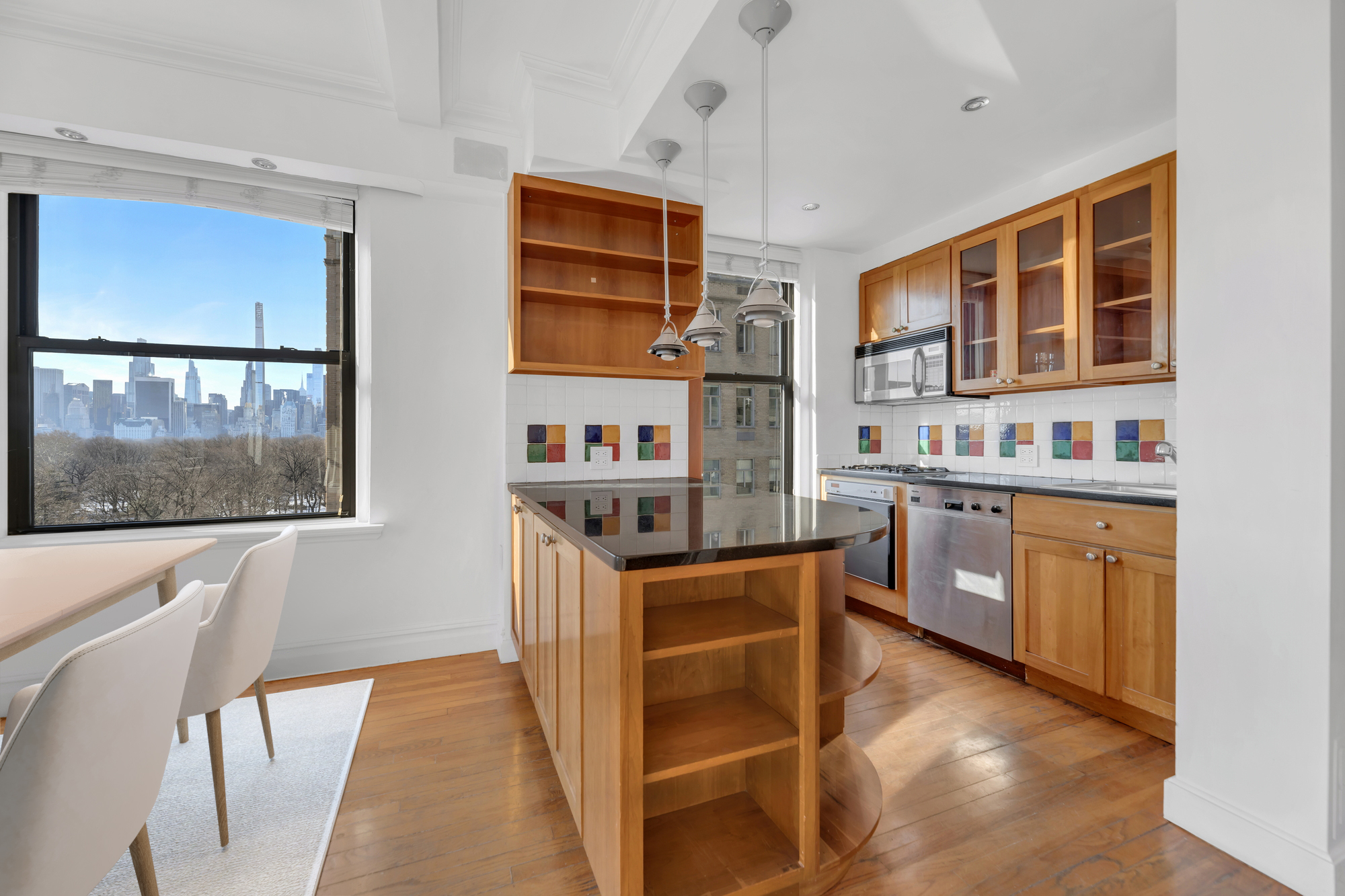 225 Central Park West, Unit 801 Manhattan, NY 10024 - Photo 7 of 21 a kitchen with stainless steel appliances granite countertop a stove a sink and a refrigerator