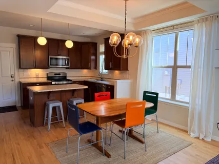 a view of a dining room with furniture and chandelier