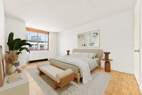 a bedroom with a large bed and a window