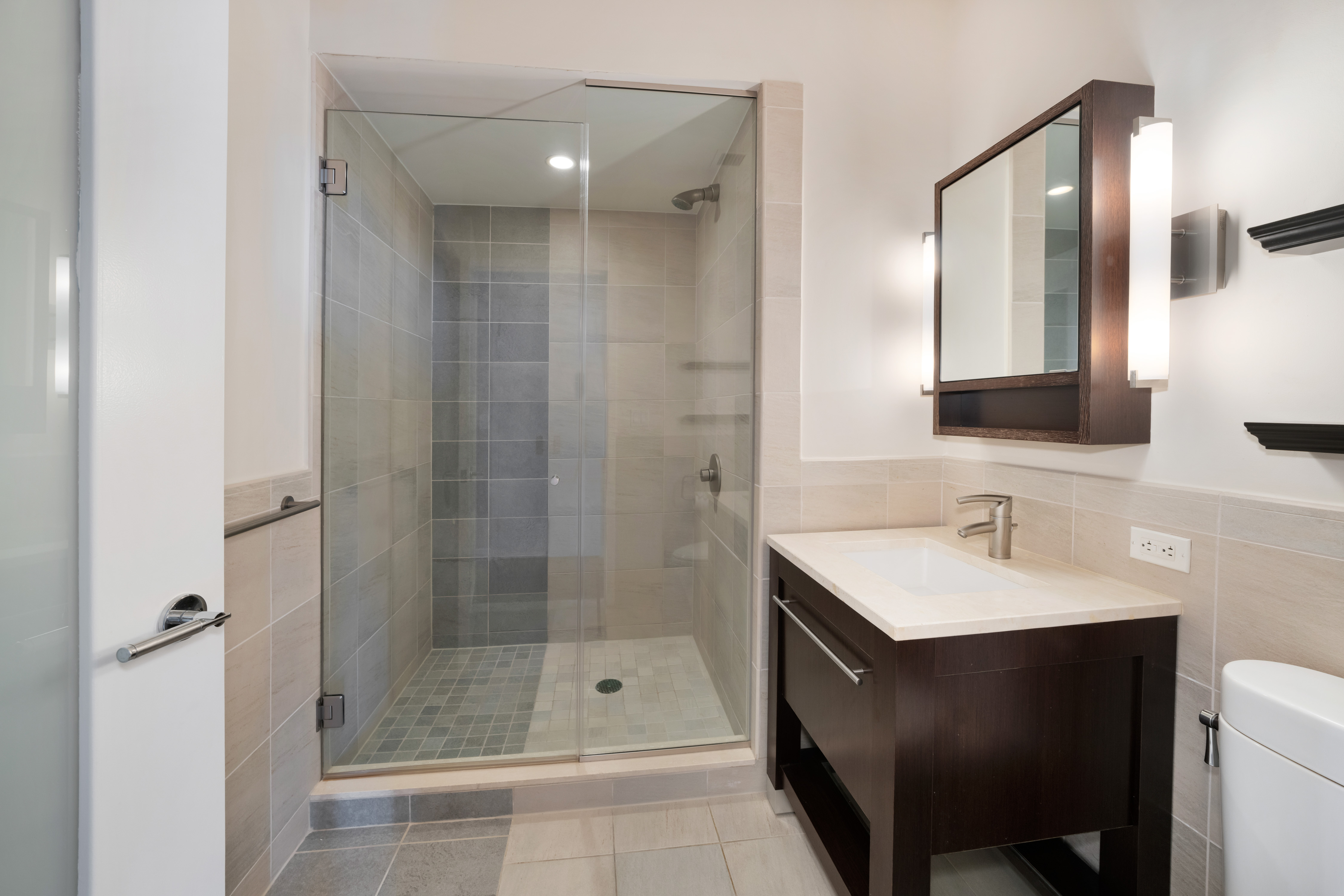 101 West 24th Street, Unit 19B Manhattan, NY 10011 - Photo 11 of 19 a bathroom with a shower a sink and a mirror