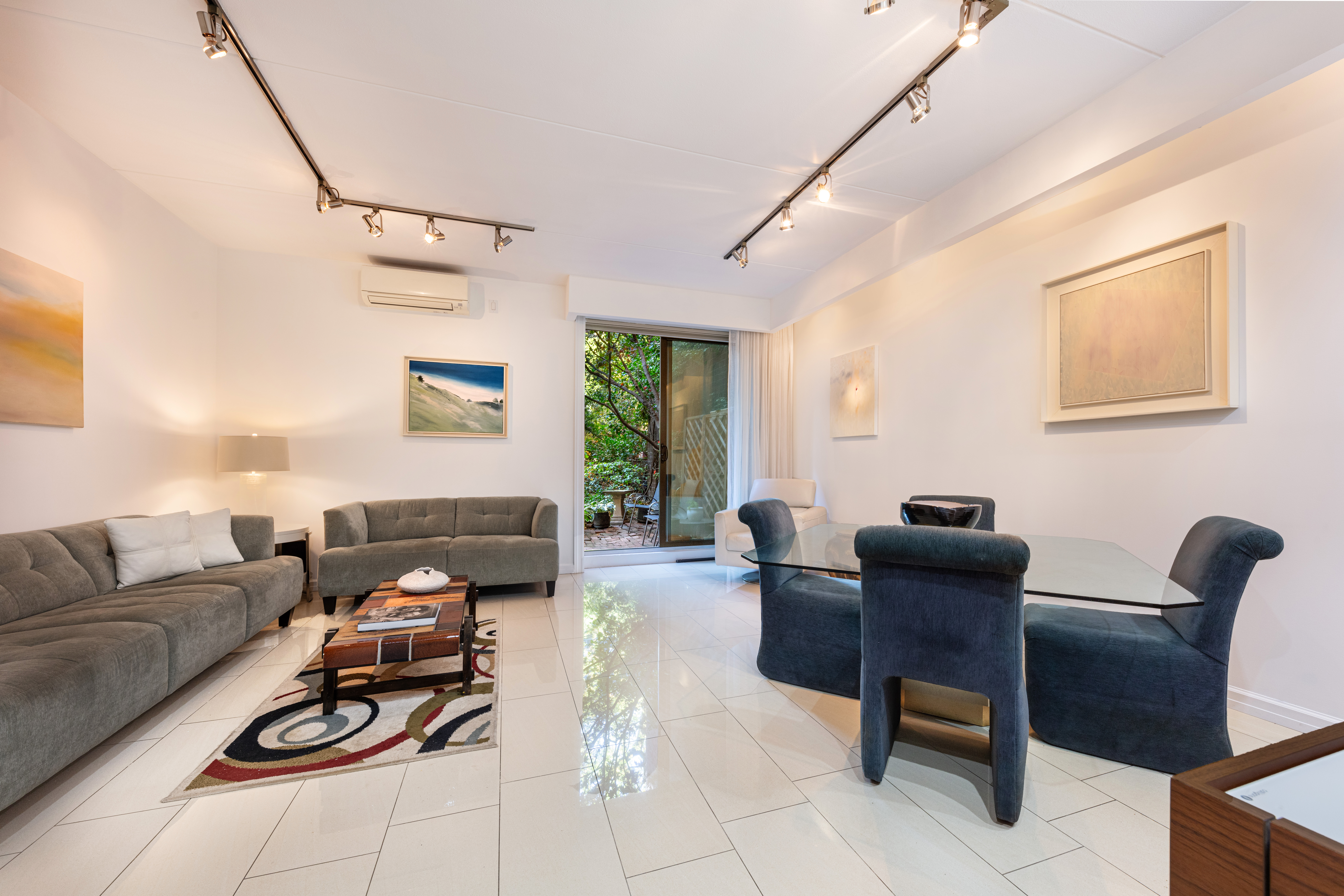 129 Barrow Street, Unit GA Manhattan, NY 10014 - Photo 1 of 17 a living room with furniture a rug and a window