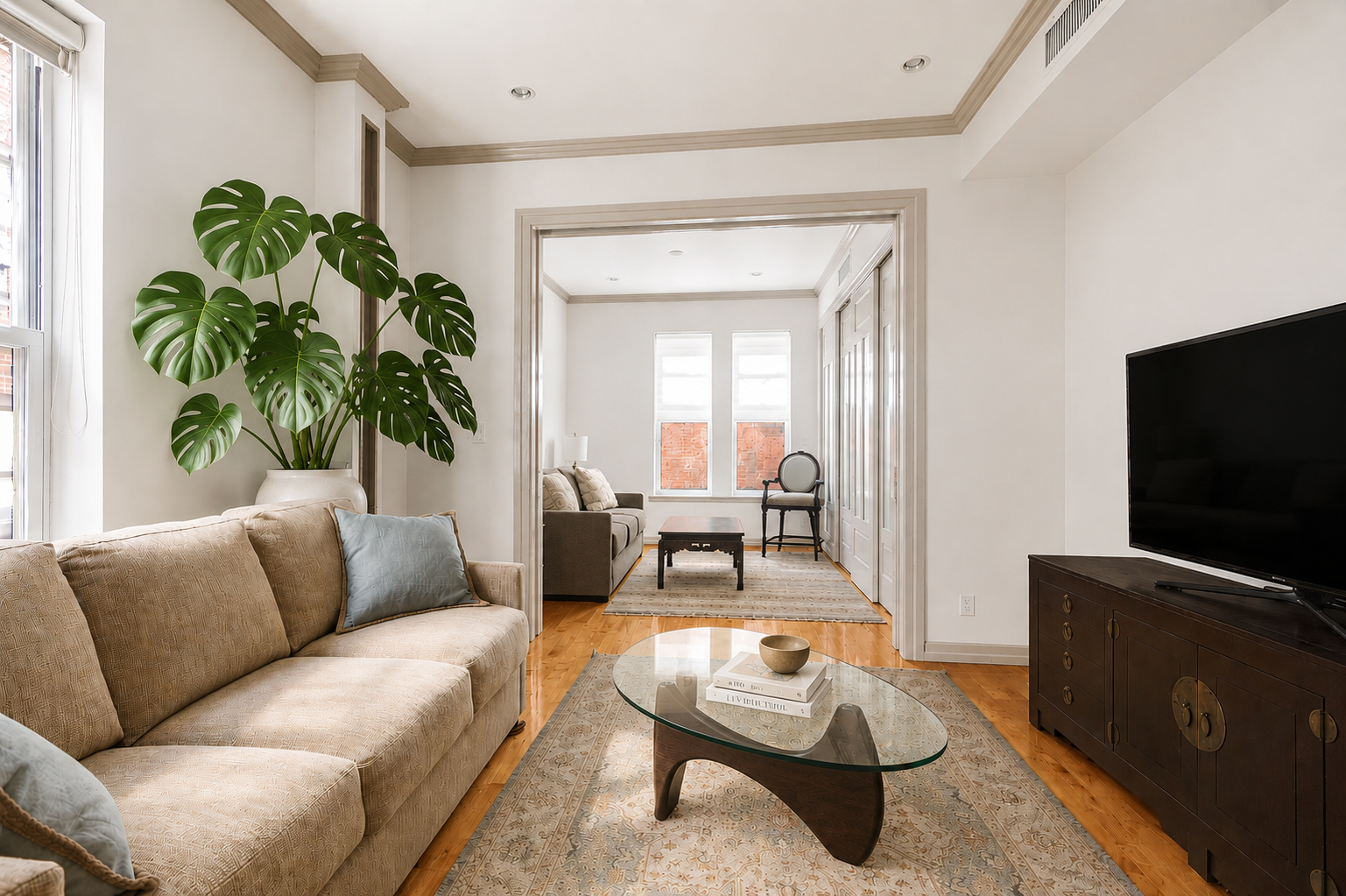 345 West 70th Street, Unit 4E Manhattan, NY 10023 - Photo 2 of 11 a living room with furniture and a flat screen tv