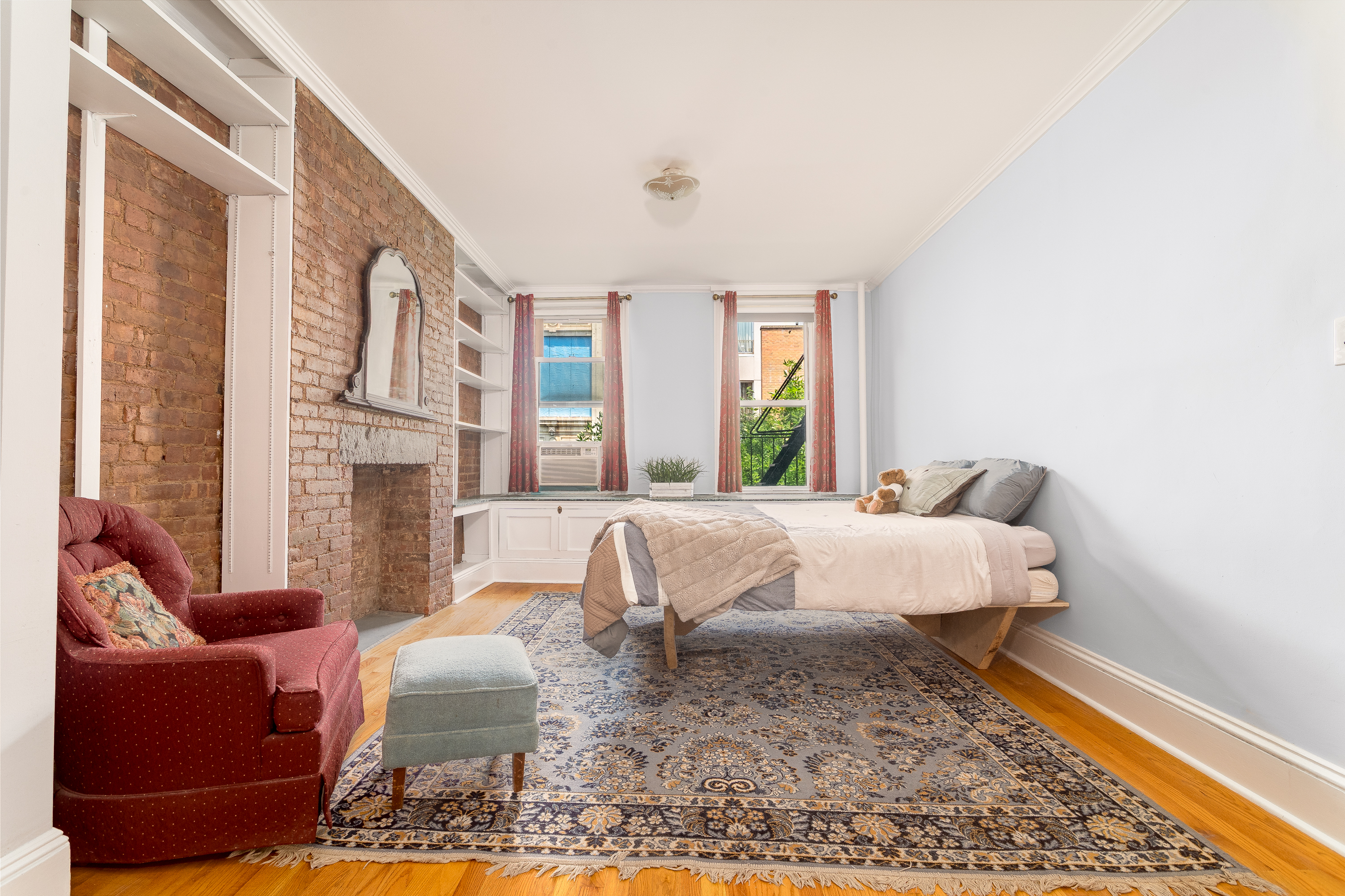 616 East 9th Street, Unit 4W Manhattan, NY 10009 - Photo 2 of 20 a bed room with a bed and a couch