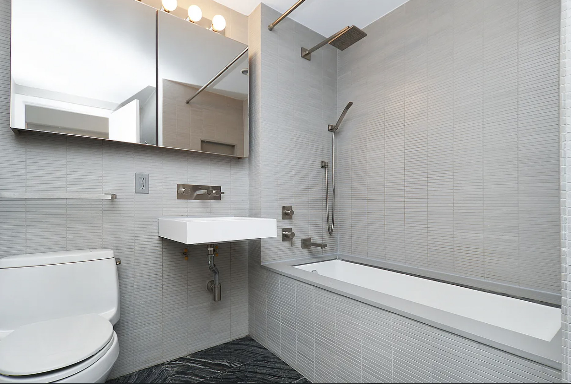 250 Bedford Avenue, Unit 129405 Brooklyn, NY 11249 - Photo 5 of 8 a bathroom with a sink a toilet and shower