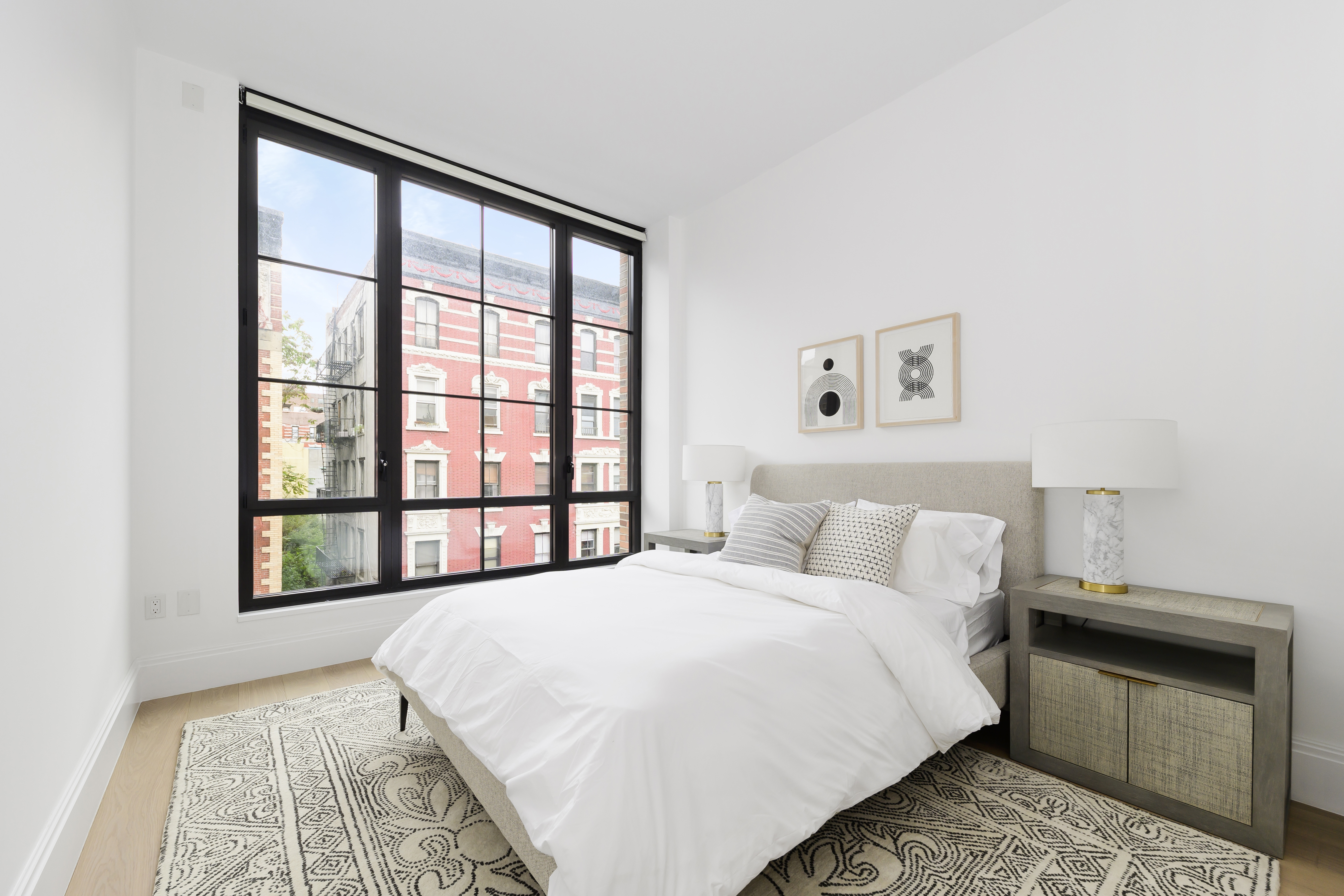 438 East 12th Street, Unit 5B Manhattan, NY 10009 - Photo 3 of 9 a bedroom with a bed and a window